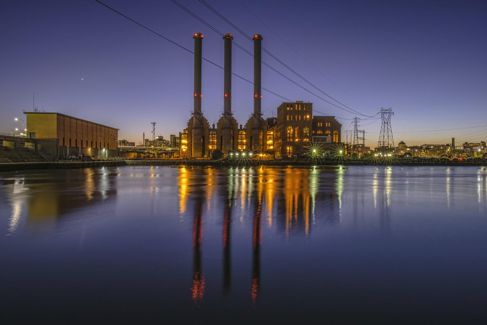 The three smokestacks of the Manchester Street power station at dusk