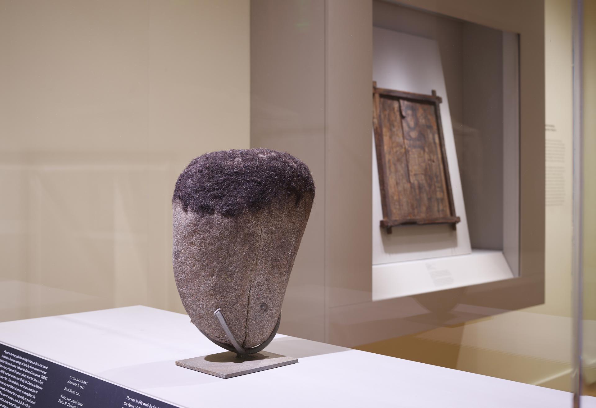 Installation shot of David Hammons "Rock Head" sculpture on view in the Egyptian gallery