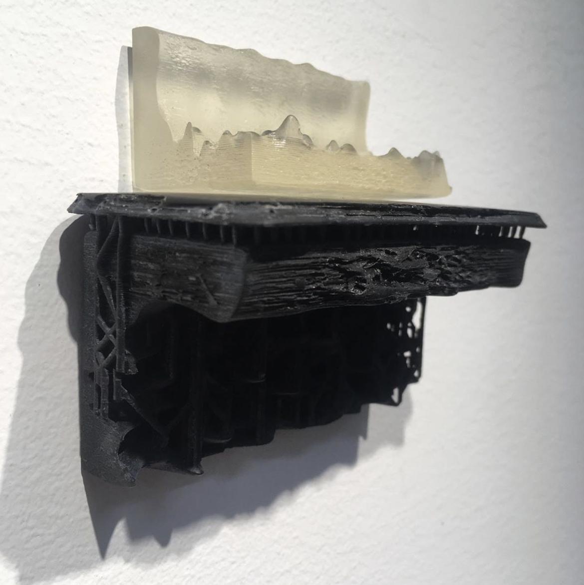 A clear representation of 3D printed waves rests on a black 3D printed mantle.
