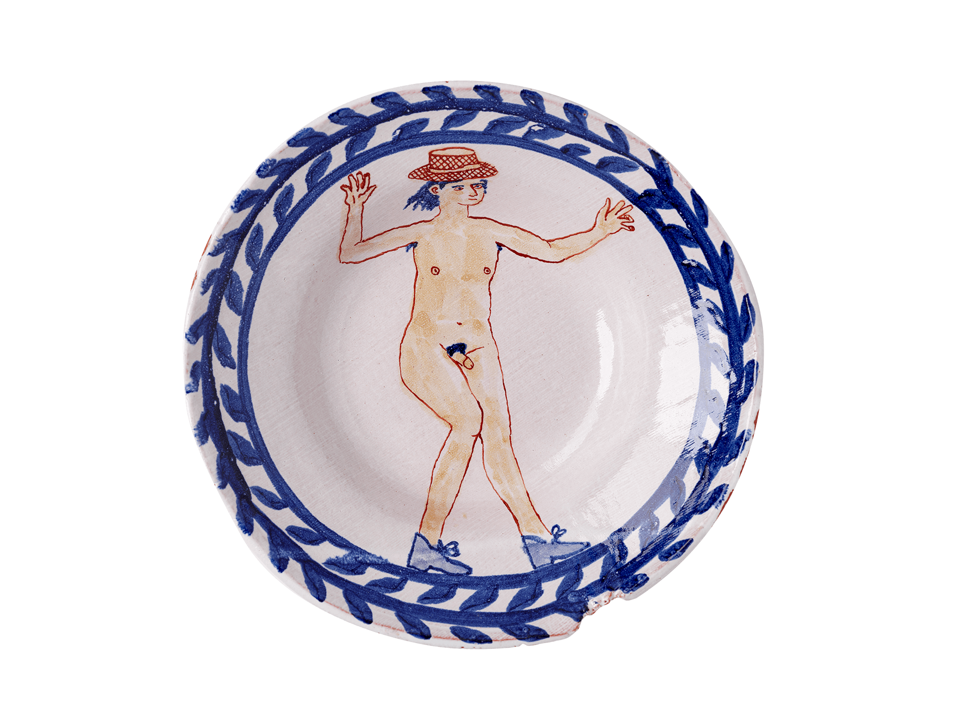 /Ceramic%20plate%20with%20a%20decorative%20floral%20border%20and%20an%20illustration%20of%20a%20dancing%20nude%20man%20wearing%20a%20full-brimmed%20hat%20and%20shoes