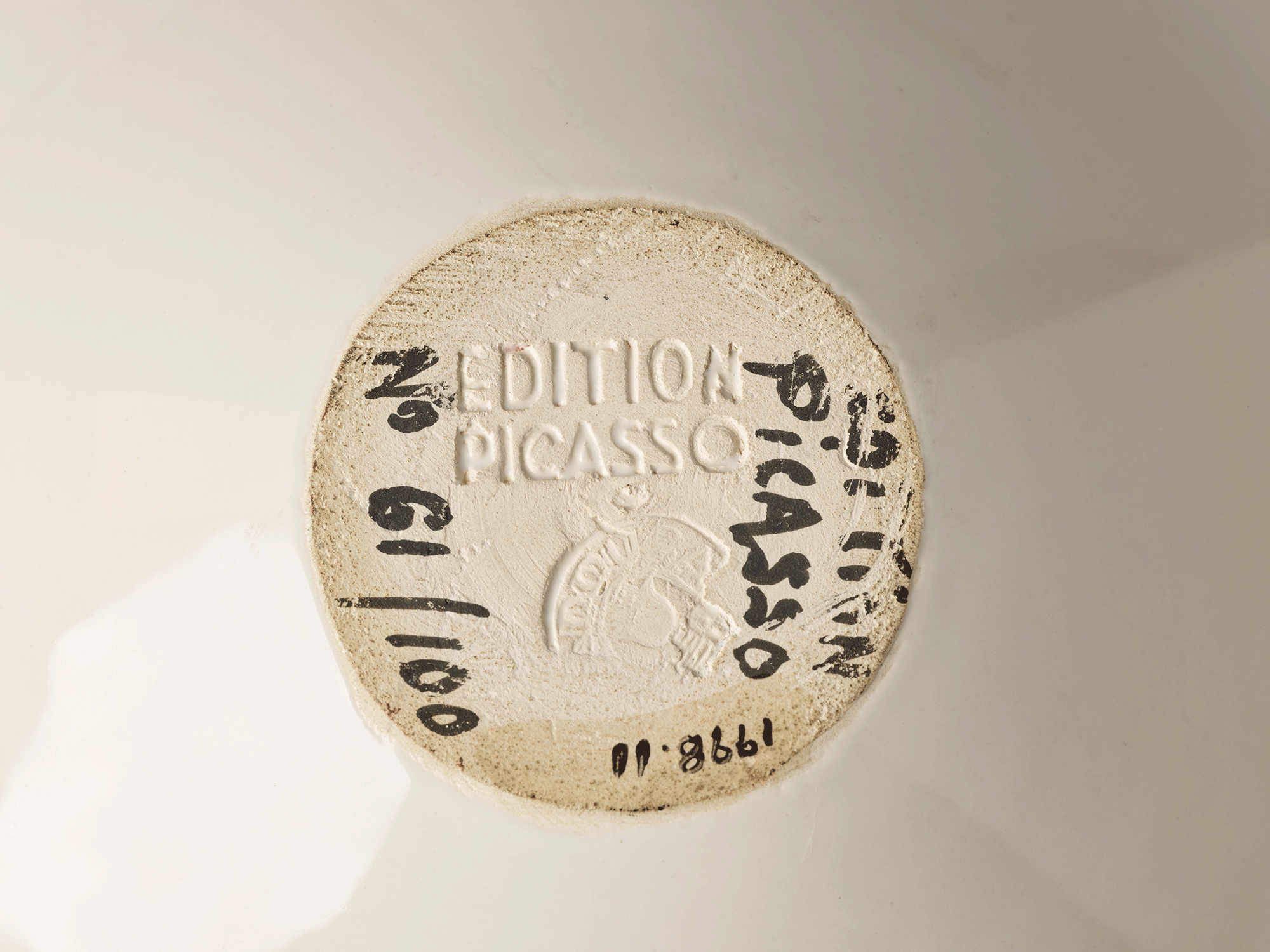 Underside of bowl. Words stamped into clay read “Edition Picasso.” Words painted in black read “No 61/100 [,] Picasso Edition.” Accession number is visible.