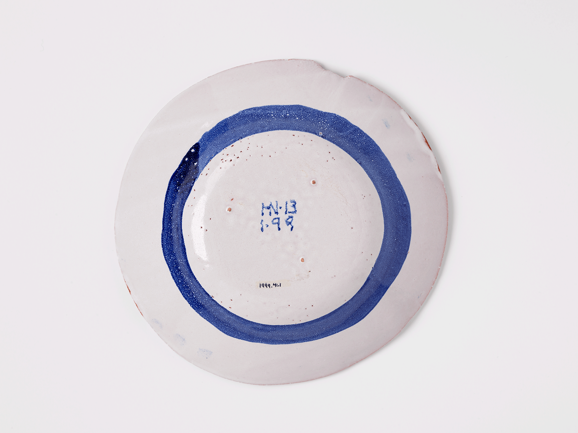 Underside of bowl. “HN 13 [,] 1 9 9” painted in blue on white. Accession number is visible.