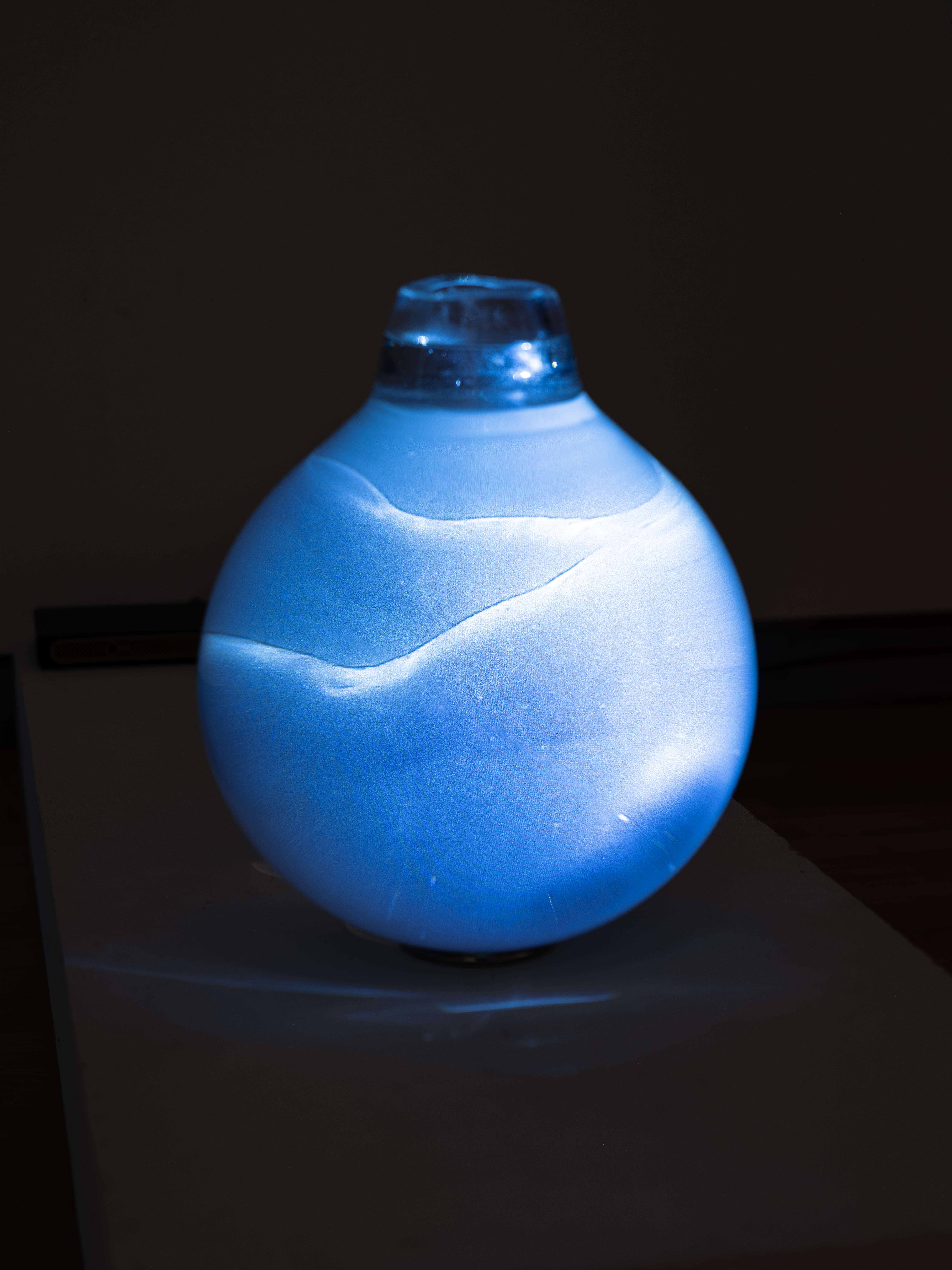 /Image%20of%20a%20glass%20orb%20with%20blue%20light%2C%20water%20and%20a%20blurry%20figure