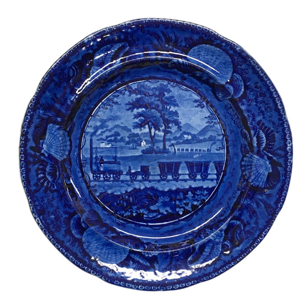 blue and white transferware plate depicting a railroad
