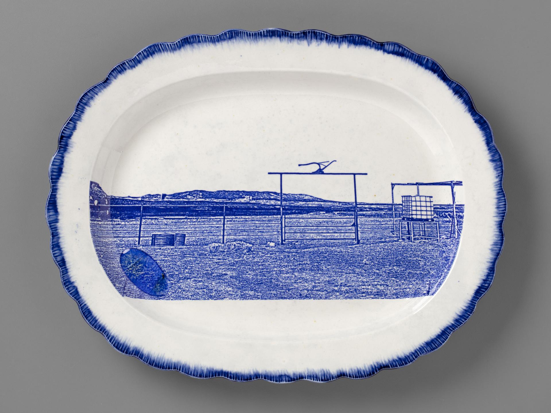 blue and white transferware platter depicting a farmstead near Cove, AZ, with melted Uranium glass on the surface