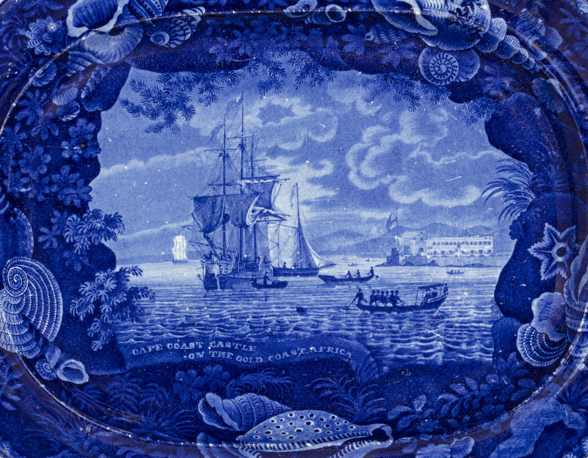 detail of the Cape Coast Castle platter, blue and white transferware depicting a slave ship with a shell border