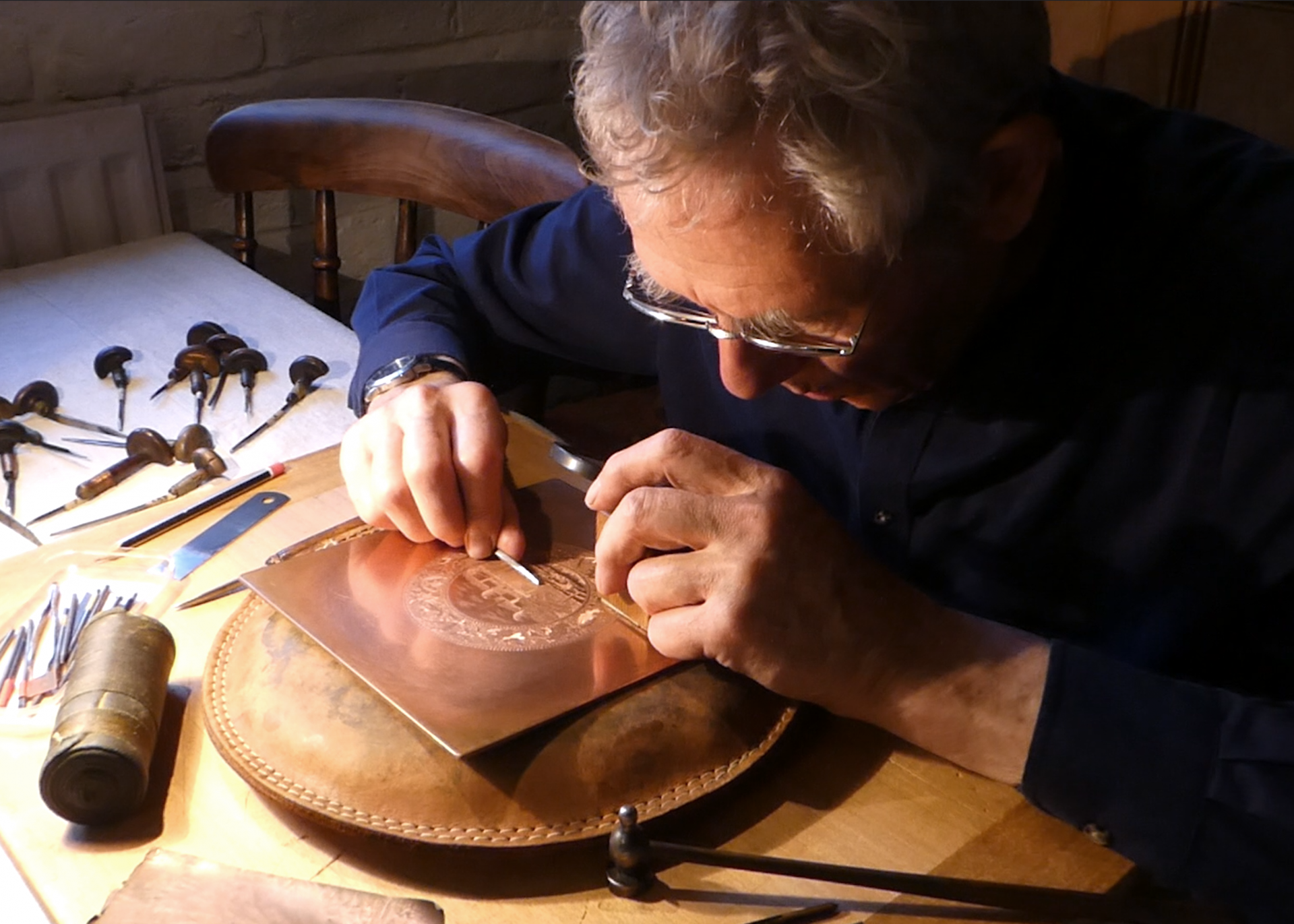 Paul Holdway engraving a copper plate