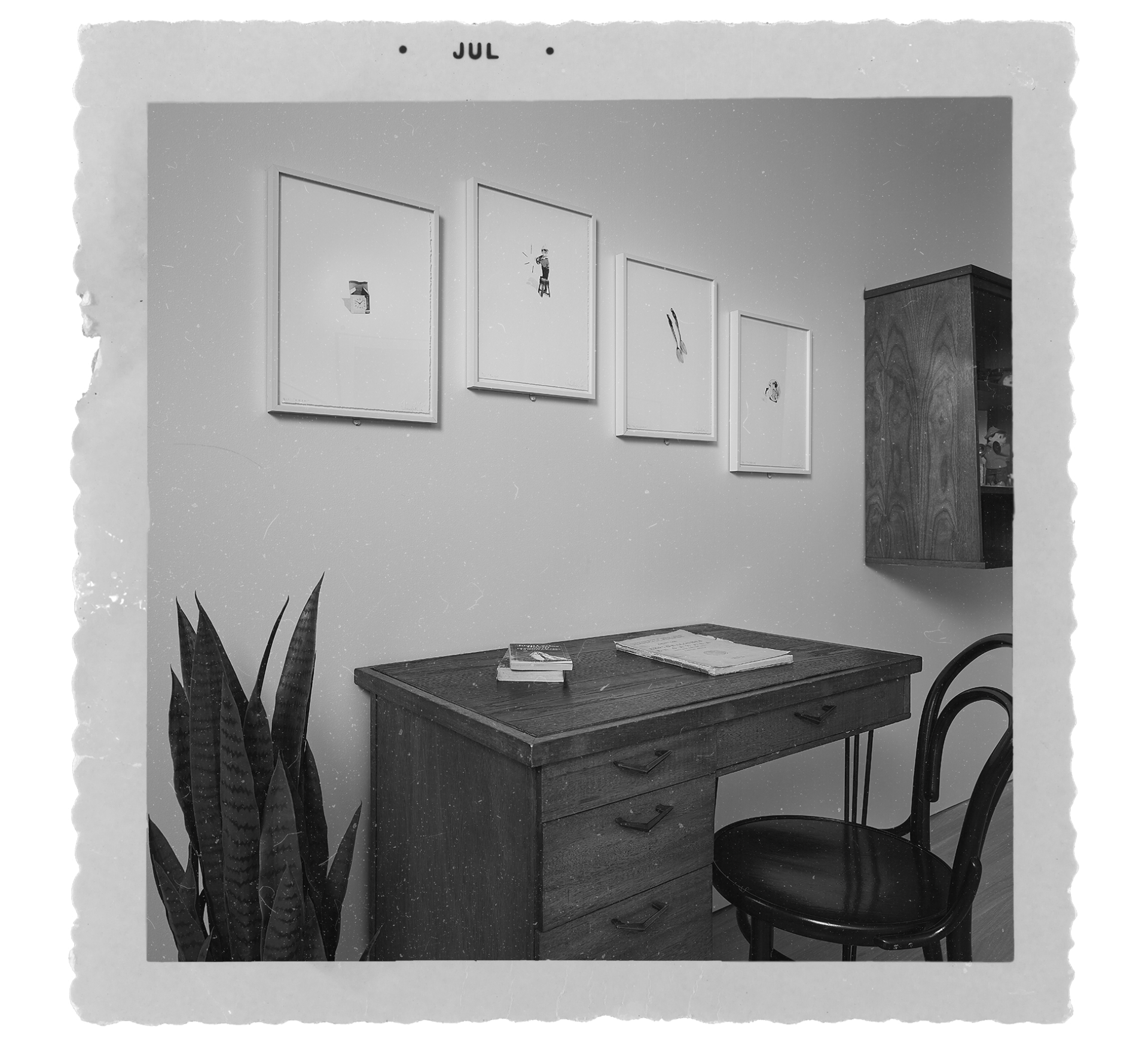 "Old" photograph of three photo-litho prints by Liliana Porter hanging on a wall above a desk