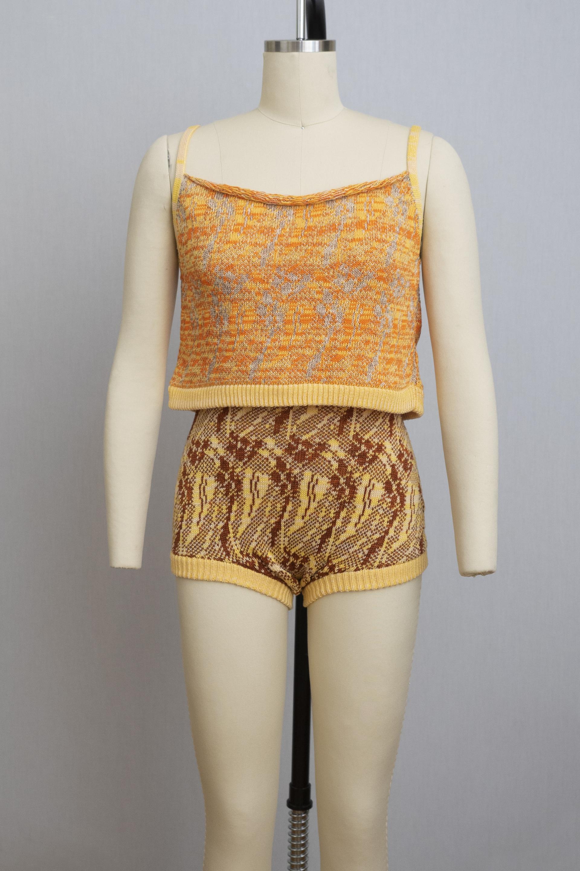 dress form wearing a knit playsuit in oranges and yellows
