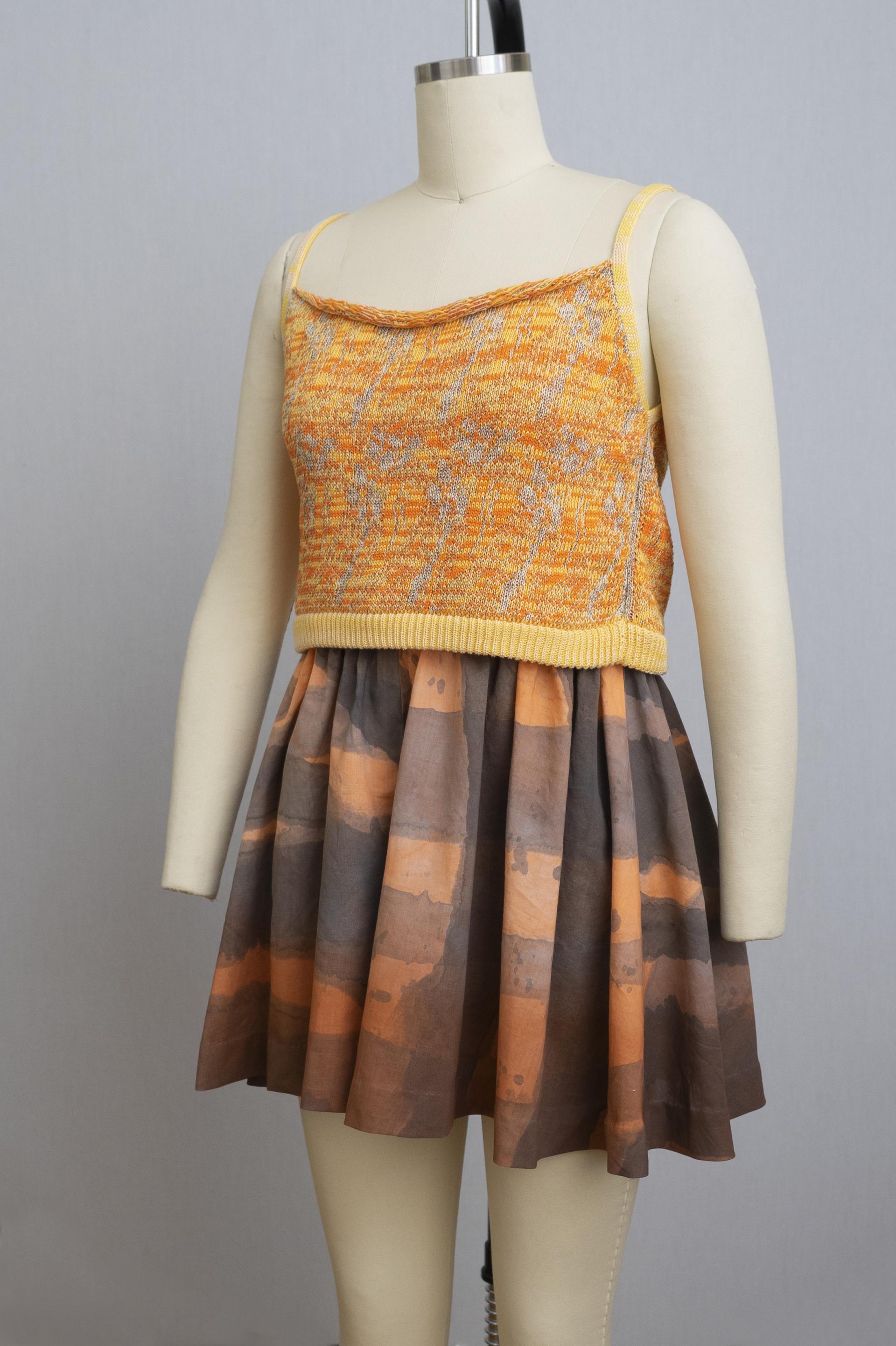 dress form wearing orange and yellow top with wide leg shorts in purple and orange