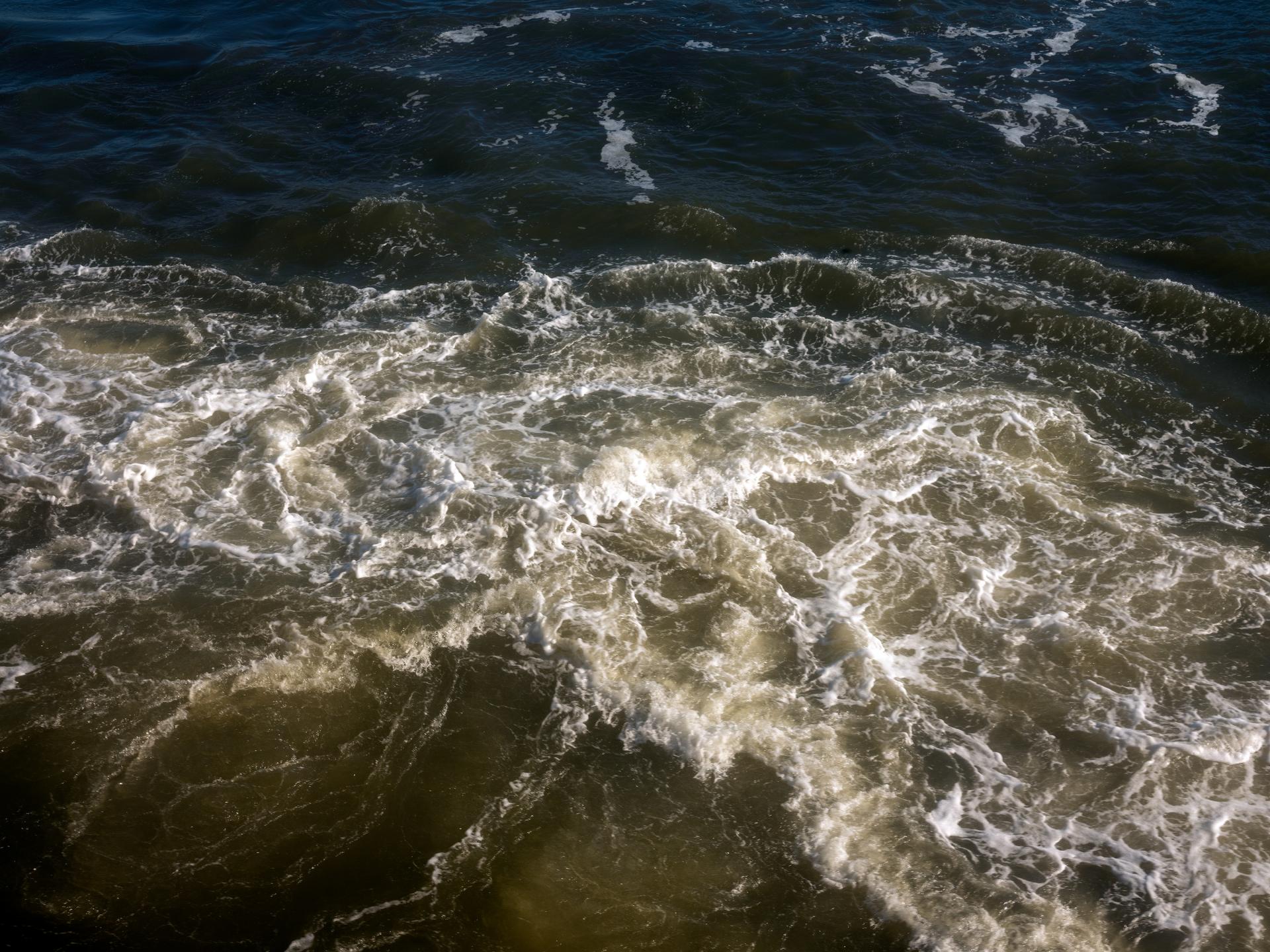 Color photograph of water churning in the Hudson River. 
