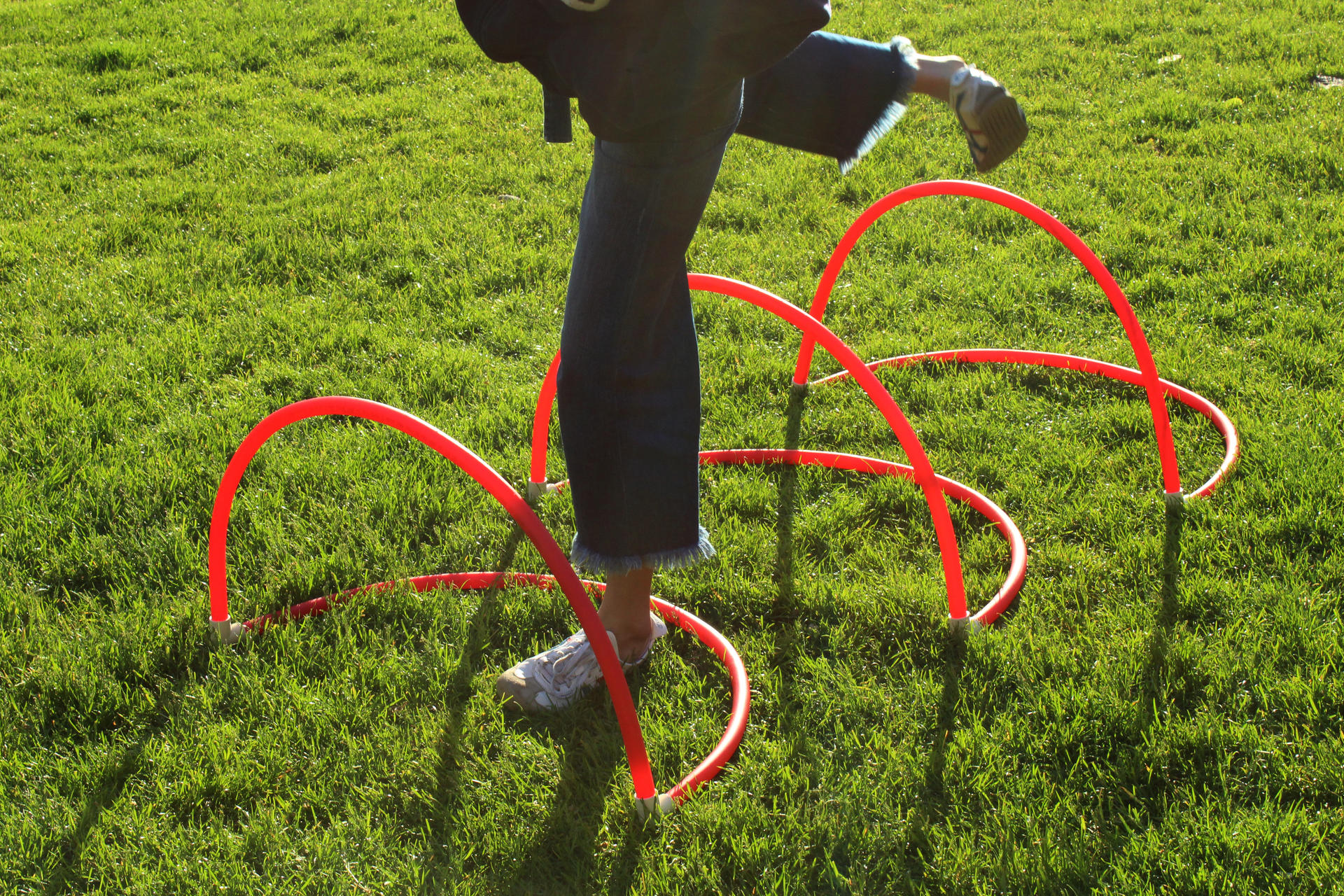 Photo of red PVC letterforms on grass