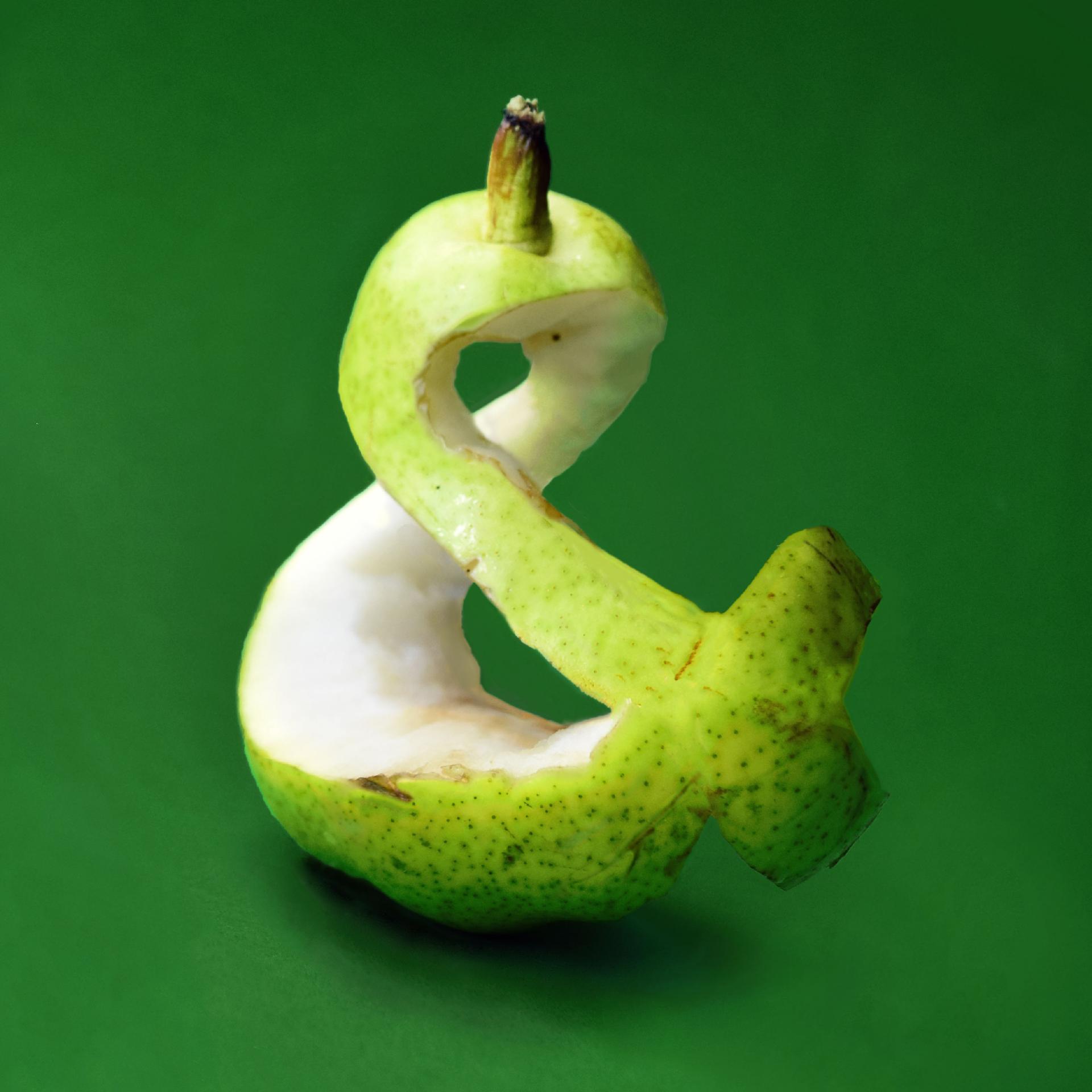 Green apple carved into an ampersand 