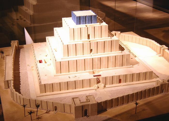 color photograph of a model of the Chogha Zanbil ziggurat. Lit from above, the model shows five-tiered square building in the desert with a wall around it.