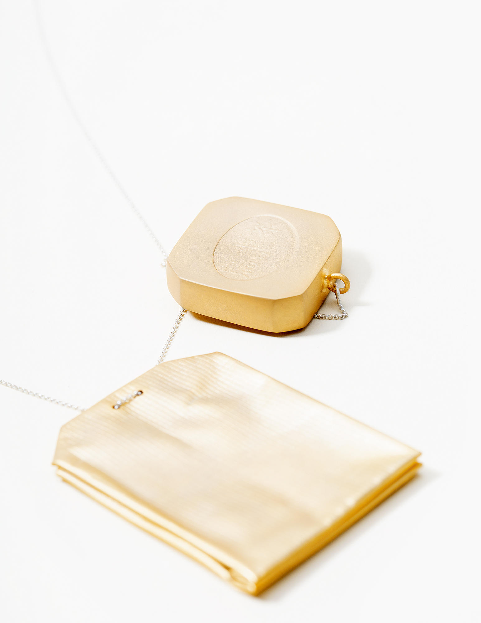 乌龙茶 (Oolong Tea) , this is a neckalce with handfabricated tea bag and tea bag tag, both plated with 14kt gold. 