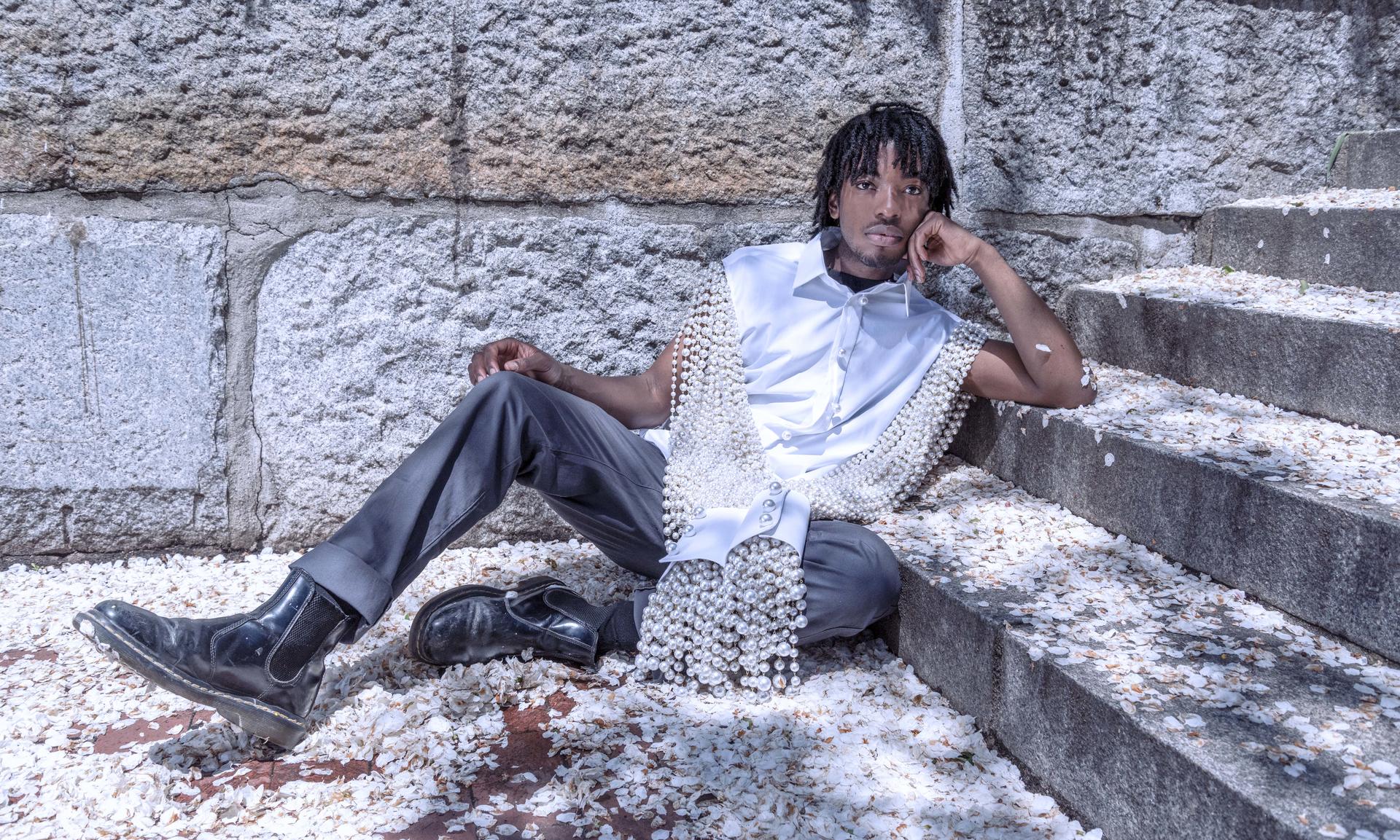 Pearl Drip, 2021, 48” x18” x 3”, Mass-produced white shirt, plastic pearl chains, plastic pearl buttons, brass