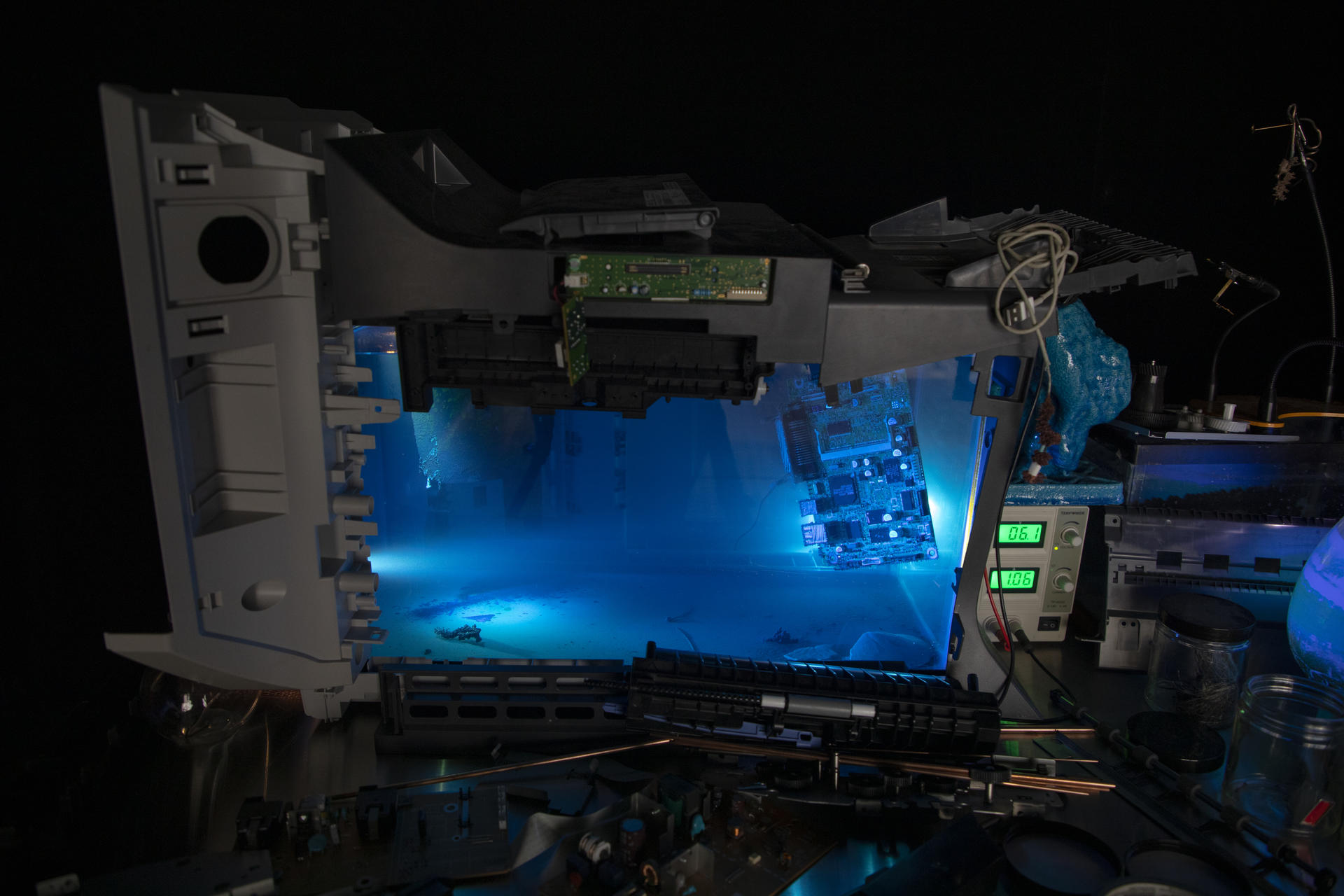 installation view, tank filled with blue liquid