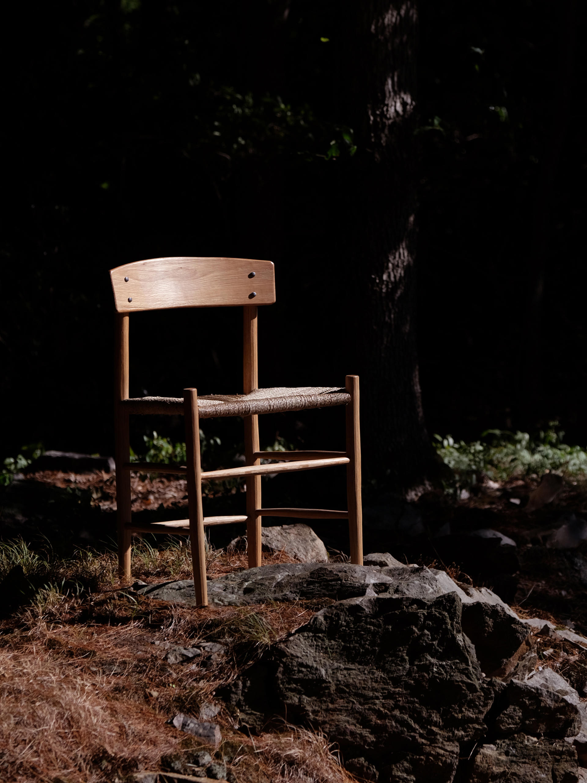 An image of Kentucky Danish in the woods. This chair is an interpretation of the J39 chair made from a log using traditional chair making techniques utilized by 1 19th craftspeople in the Appalachian Mountains.8th and