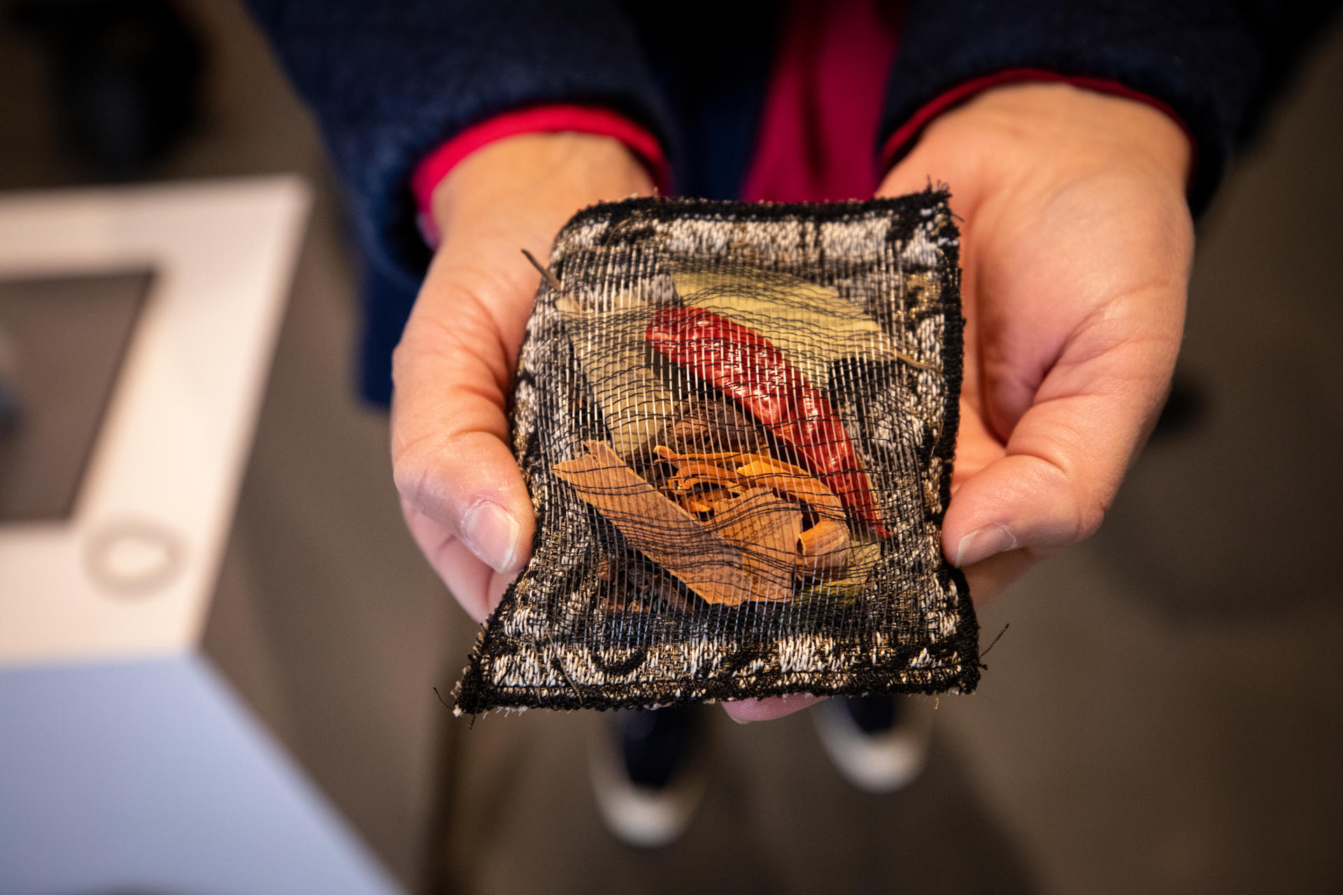 image of Jacquard pouch with spices being held 
