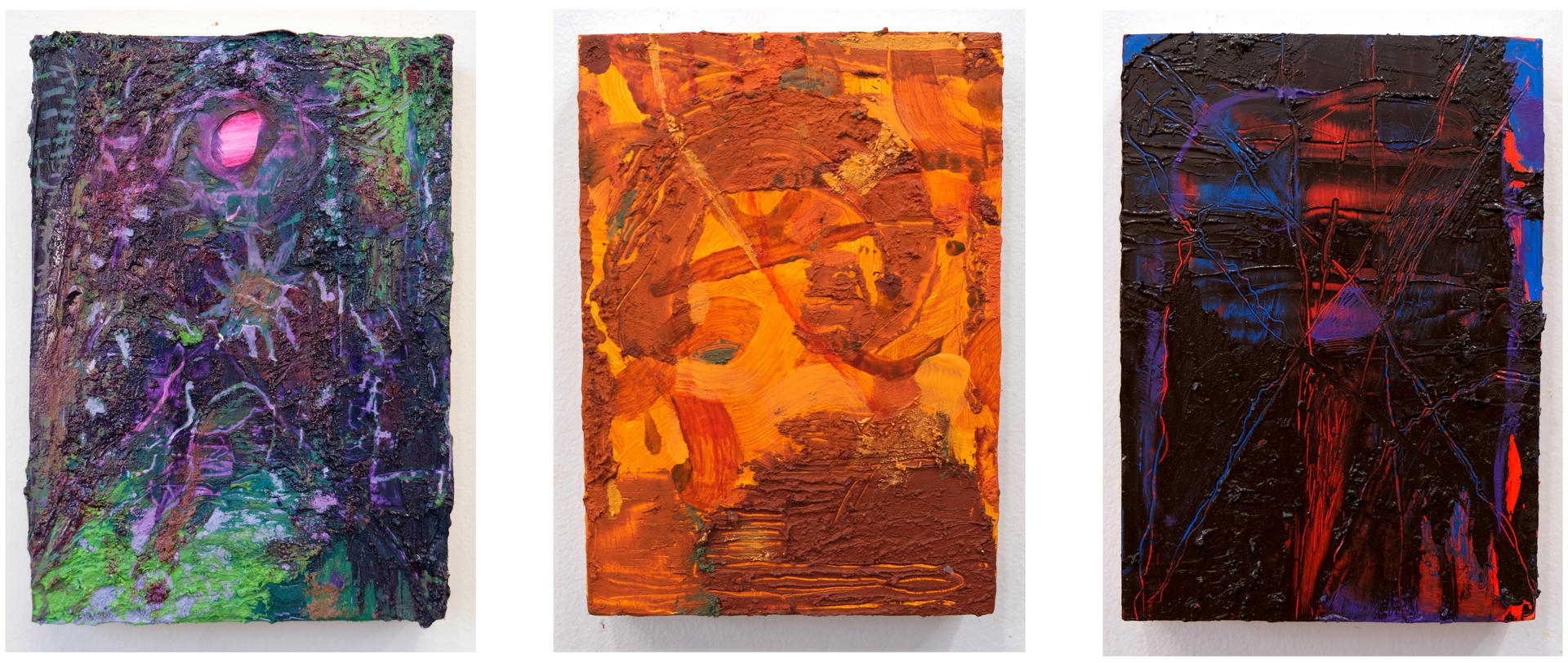 Photo of three small, abstract oil paintings.