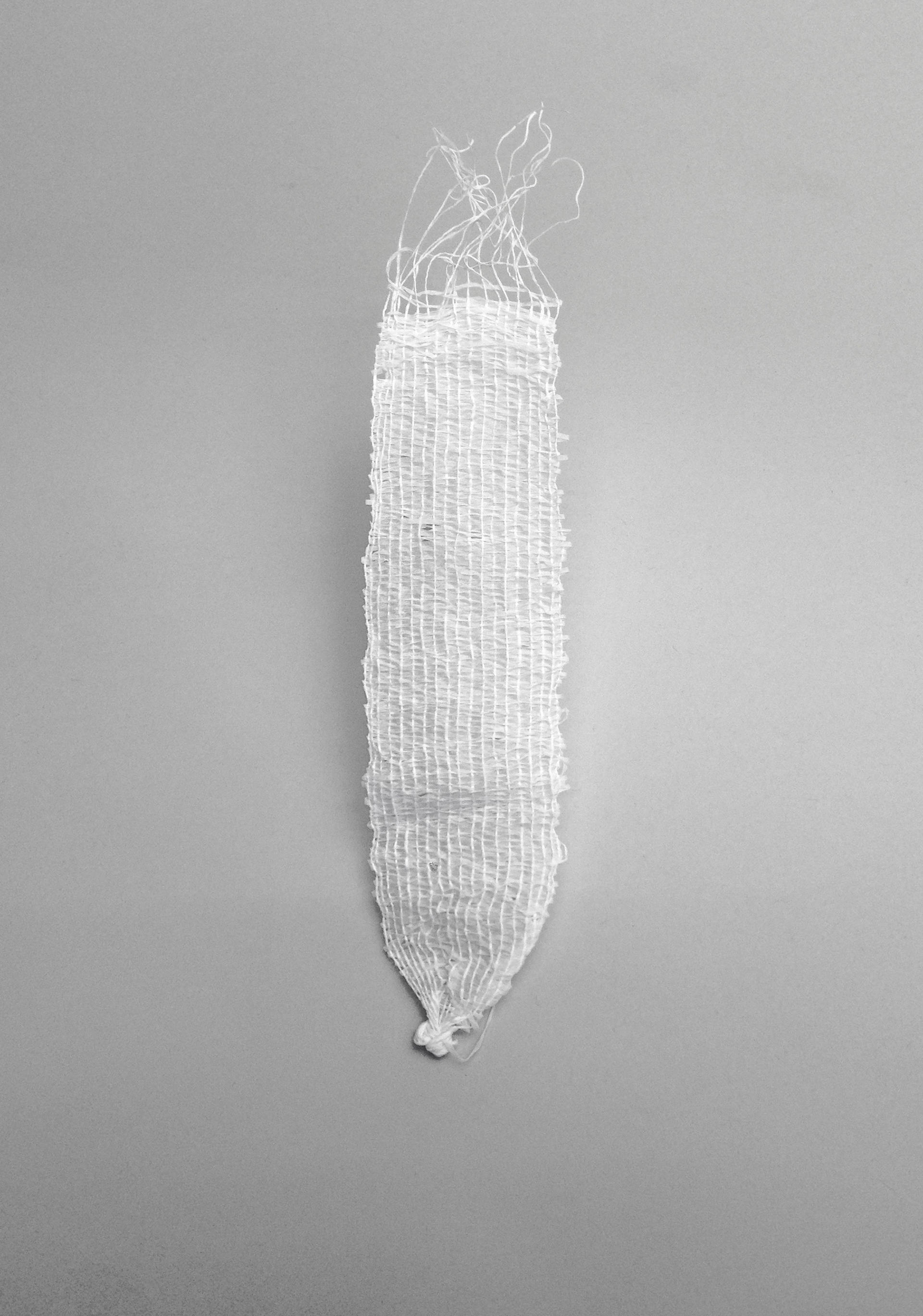 White, roughly woven strip which converges to a knot at the bottom. The top edges are frayed with loose threads.