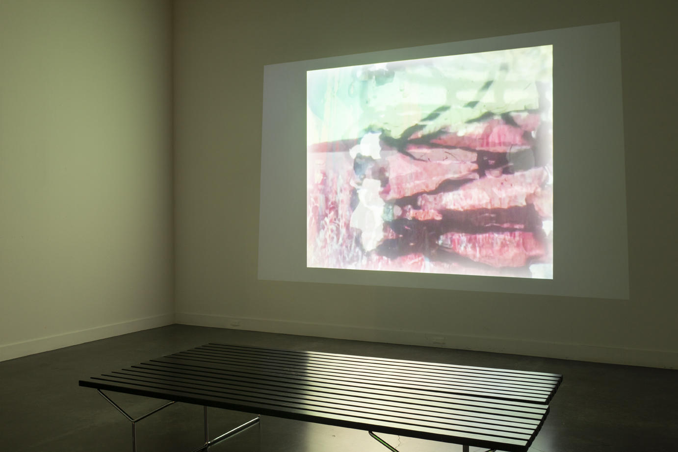 gallery interior; abstract colorful image projected onto a wall