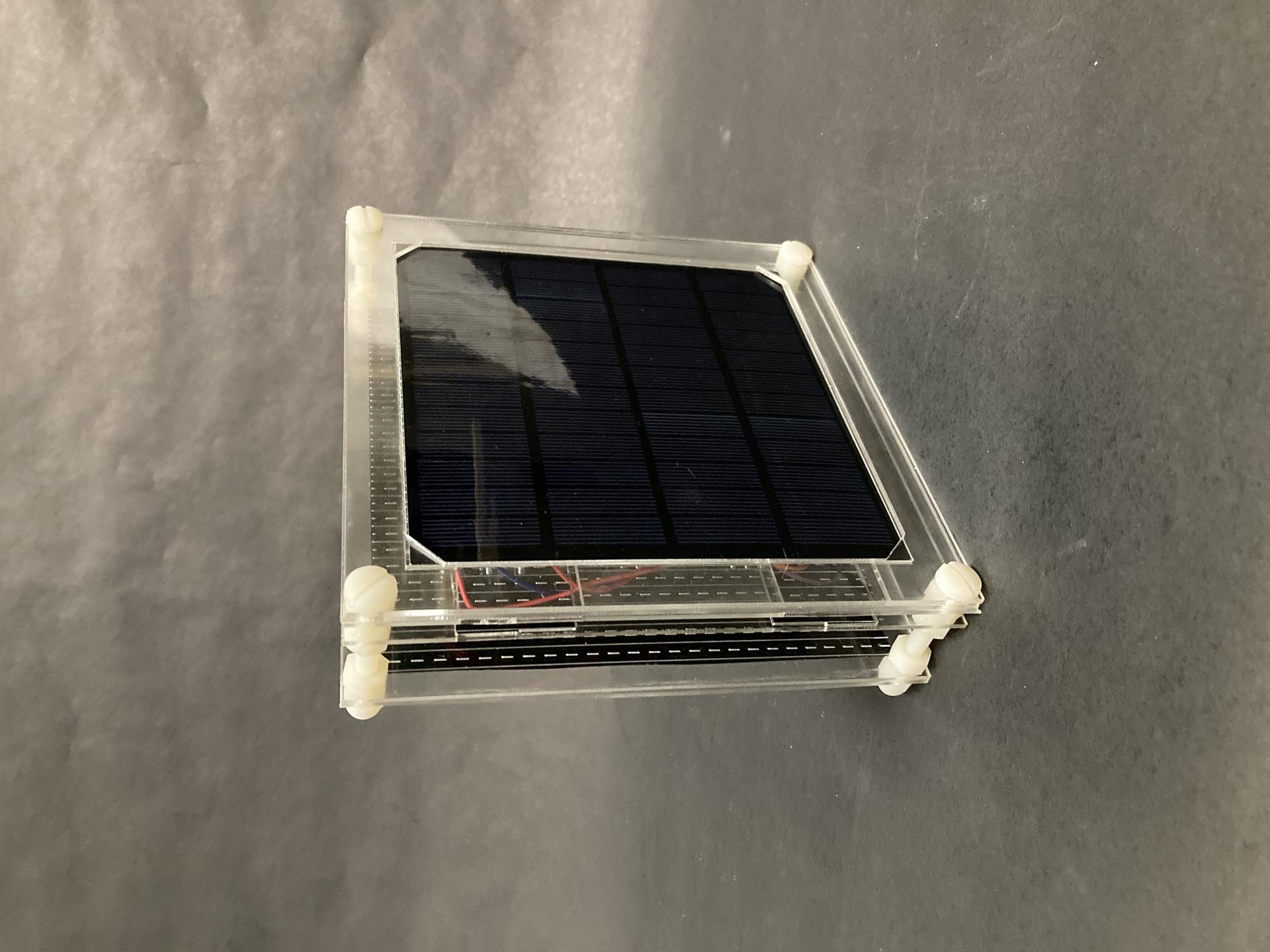 A framed solar cell, sitting on the table.