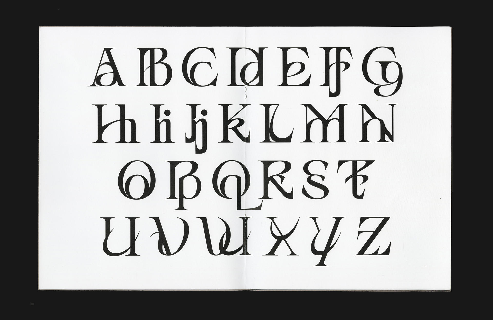 Type specimen spread, showing alphabet.