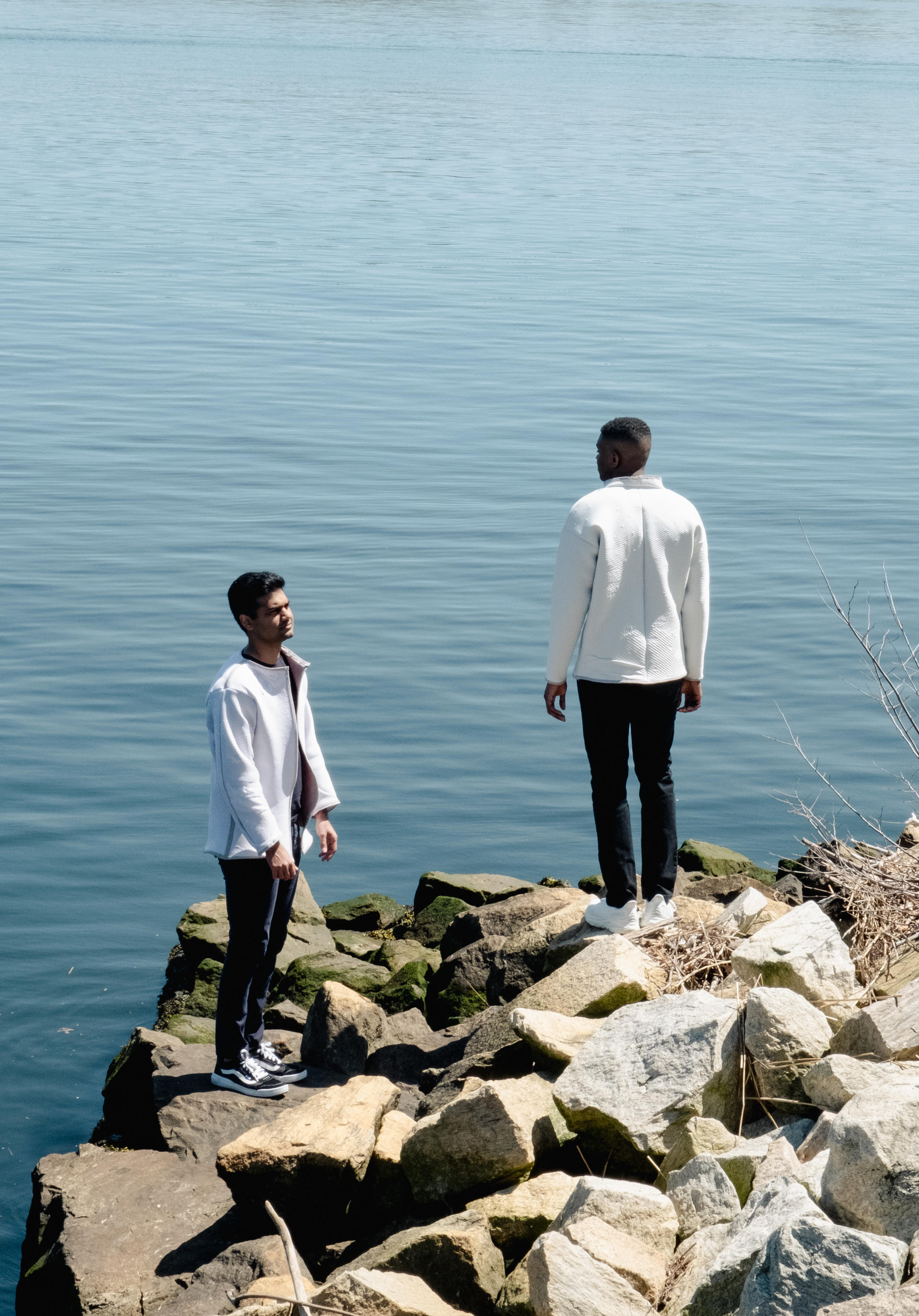 An image of two discreet humans, wearing garments applied with a phase-changing dye that reacts when in contact with volatile organic compounds.