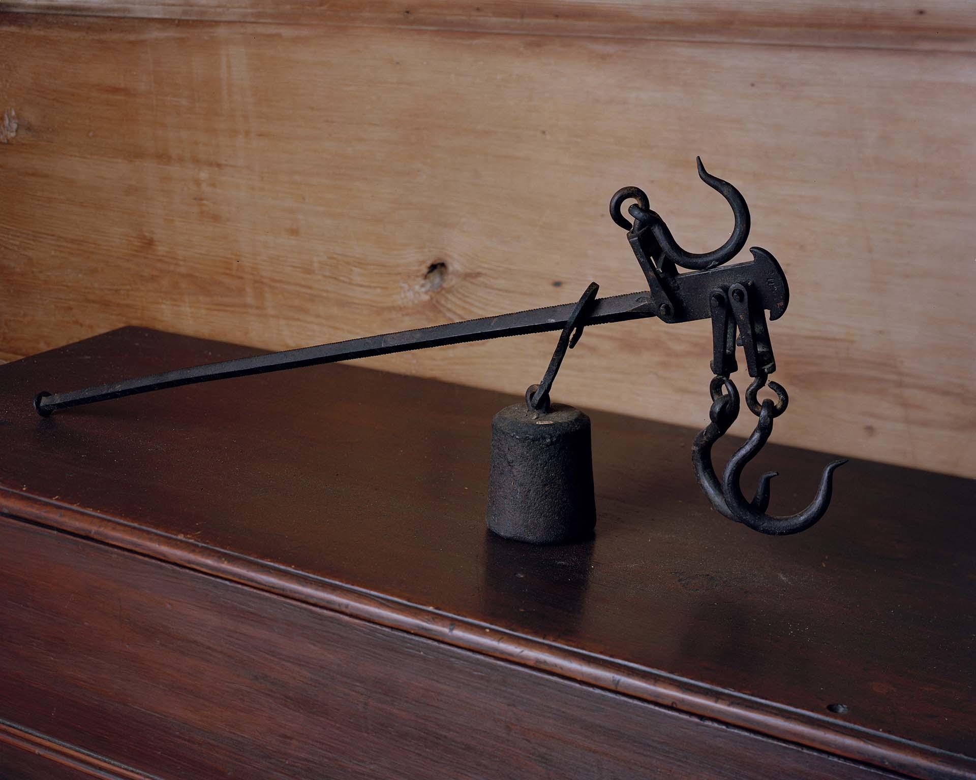 Photograph of a singular cotton scale on top of a dresser. 