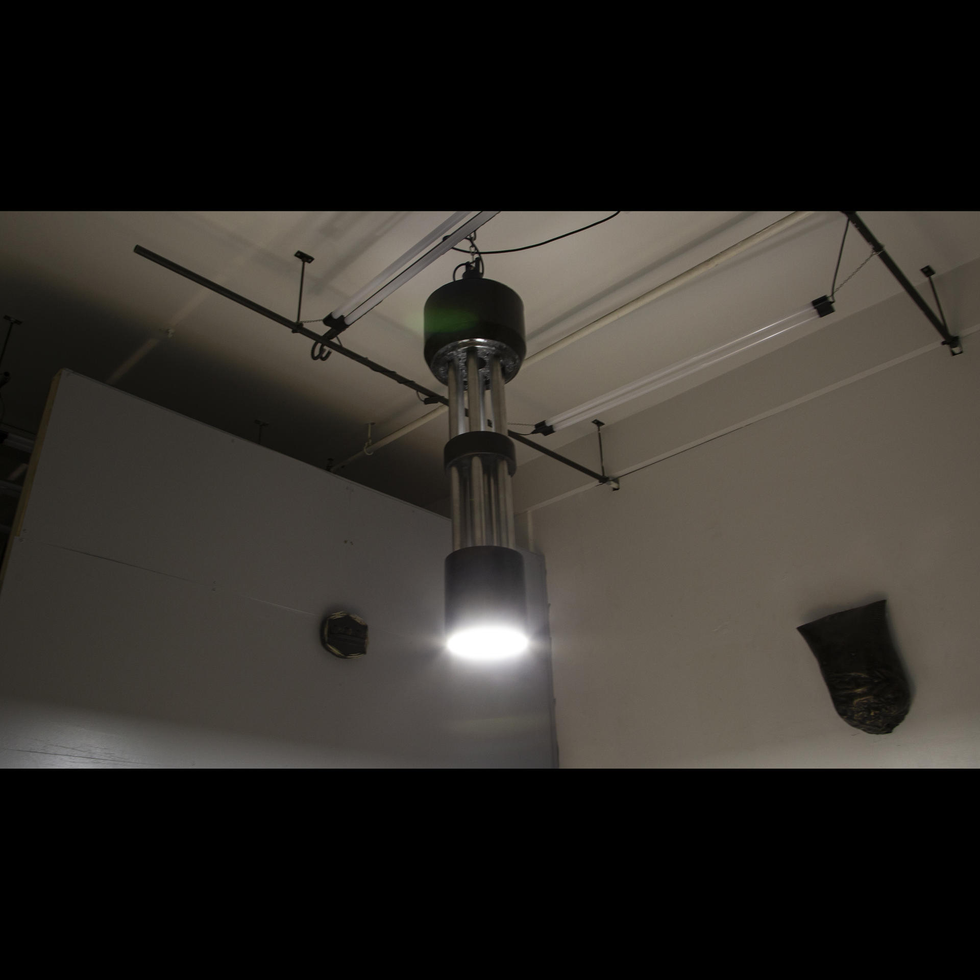 Chandelier roughly four feet tall and fourteen inches in diameter, the chandelier is modeled after and in close scale to air cannon's found on combat aircraft, this chandelier is constructed of rapid prototyping extrusion covered in carbon fiber, the light segments are aluminum.