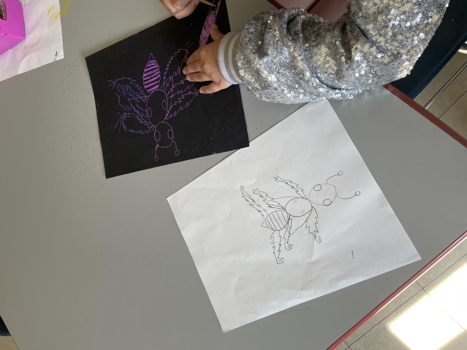 Students use wooden tools to etch into their tempera paint, uncovering color underneath the surface to create an insect with lines. 
