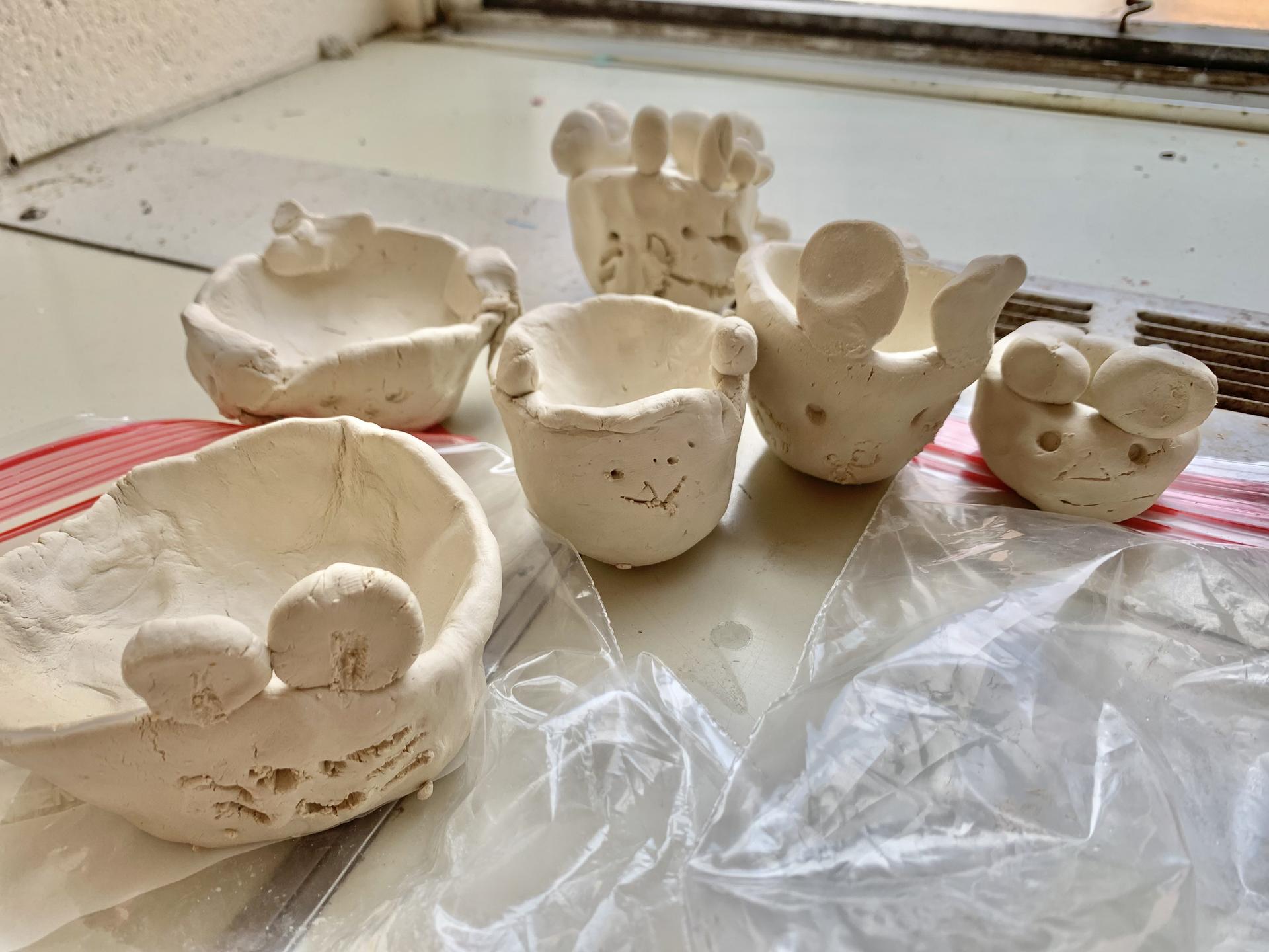 Variously sized pinch pots that represent different items that the children deemed important to them