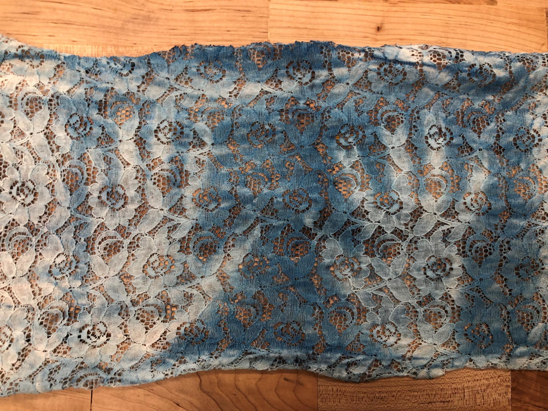 Remnants of handprints on lace due to cyanotype.