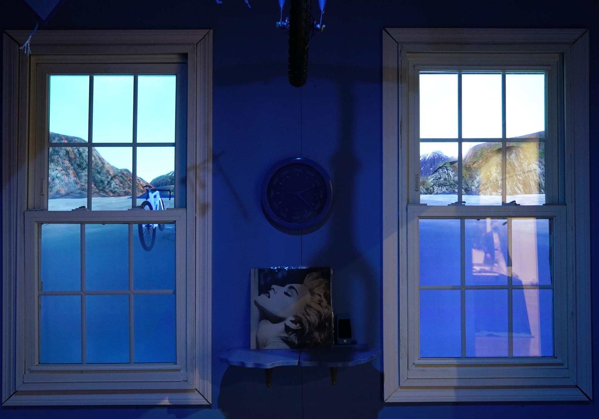 Self-playing video game displayed across two monitors, installed behind two windows