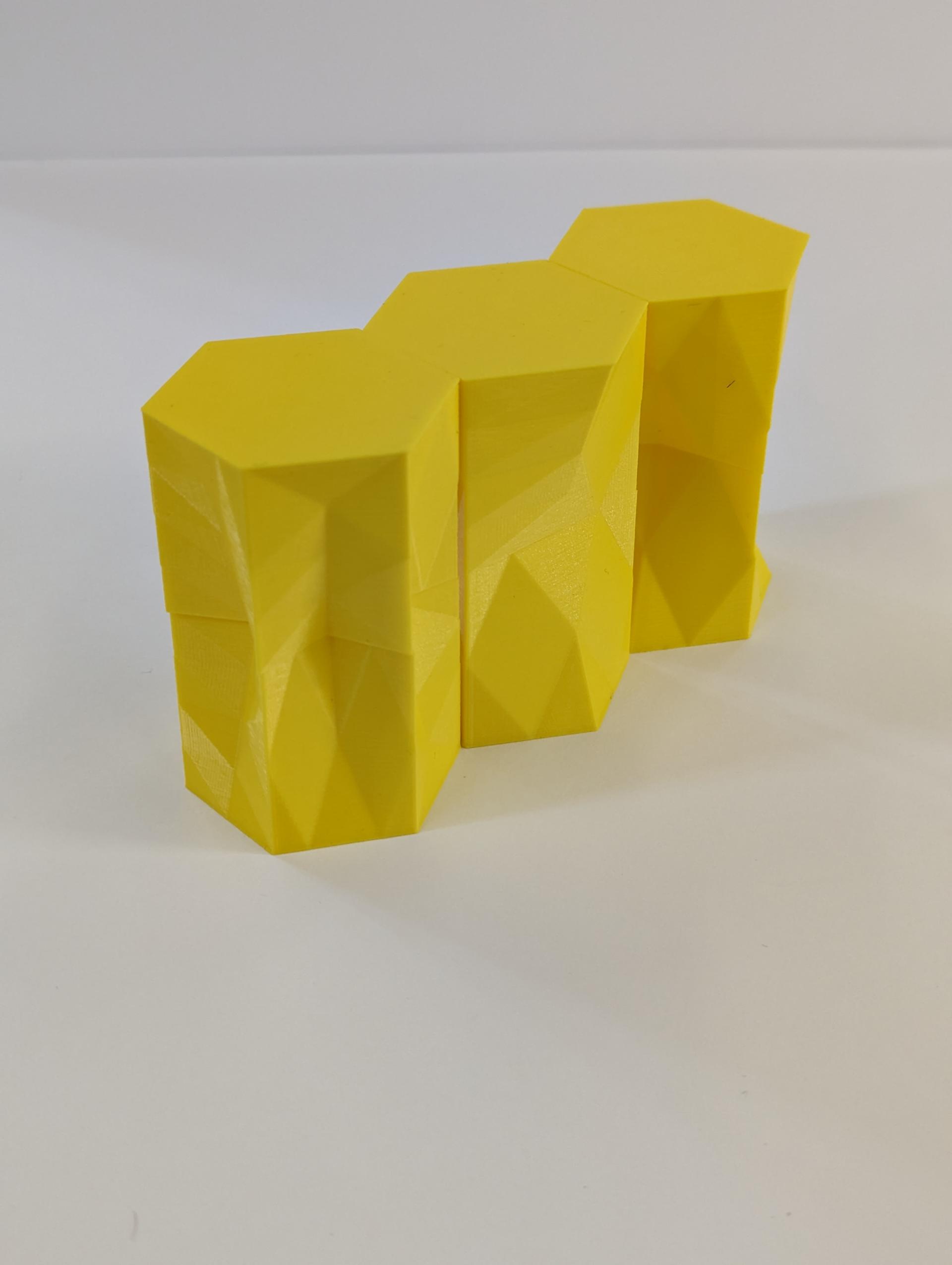 Small 3D printed extrusions translate from hexagons to other shapes and back to hexagons.