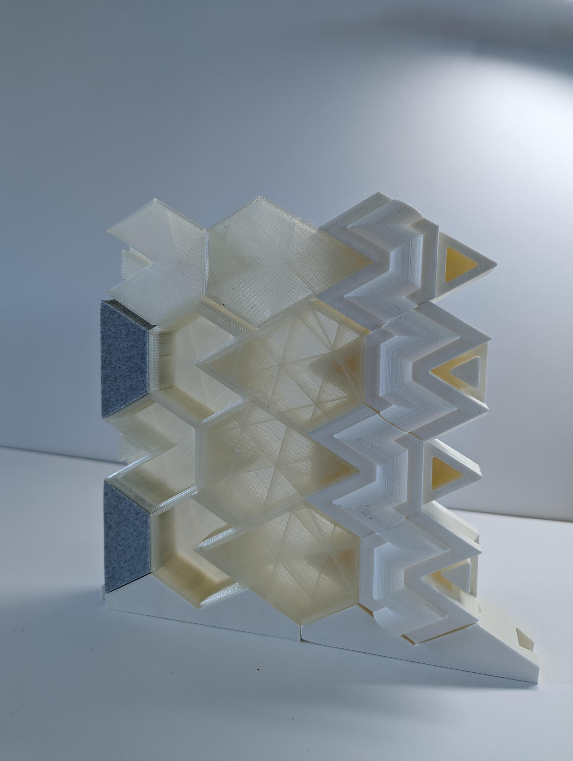 Hexagon based building blocks made from translucent filament are stacked as a scale wall assembly.