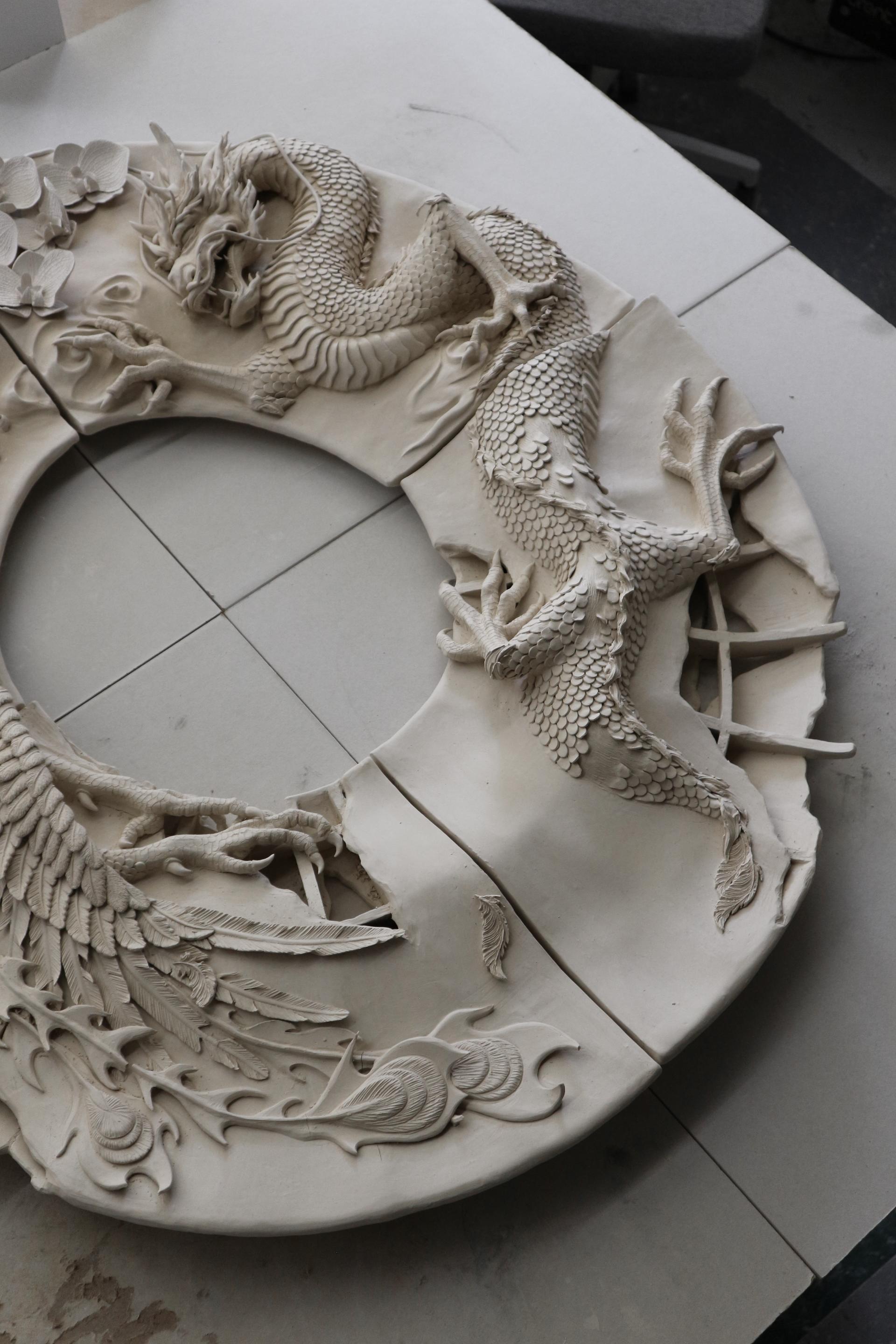 Large ceramic mirror frame with a detailed dragon, phoenix and orchid sculptures on the surface. 