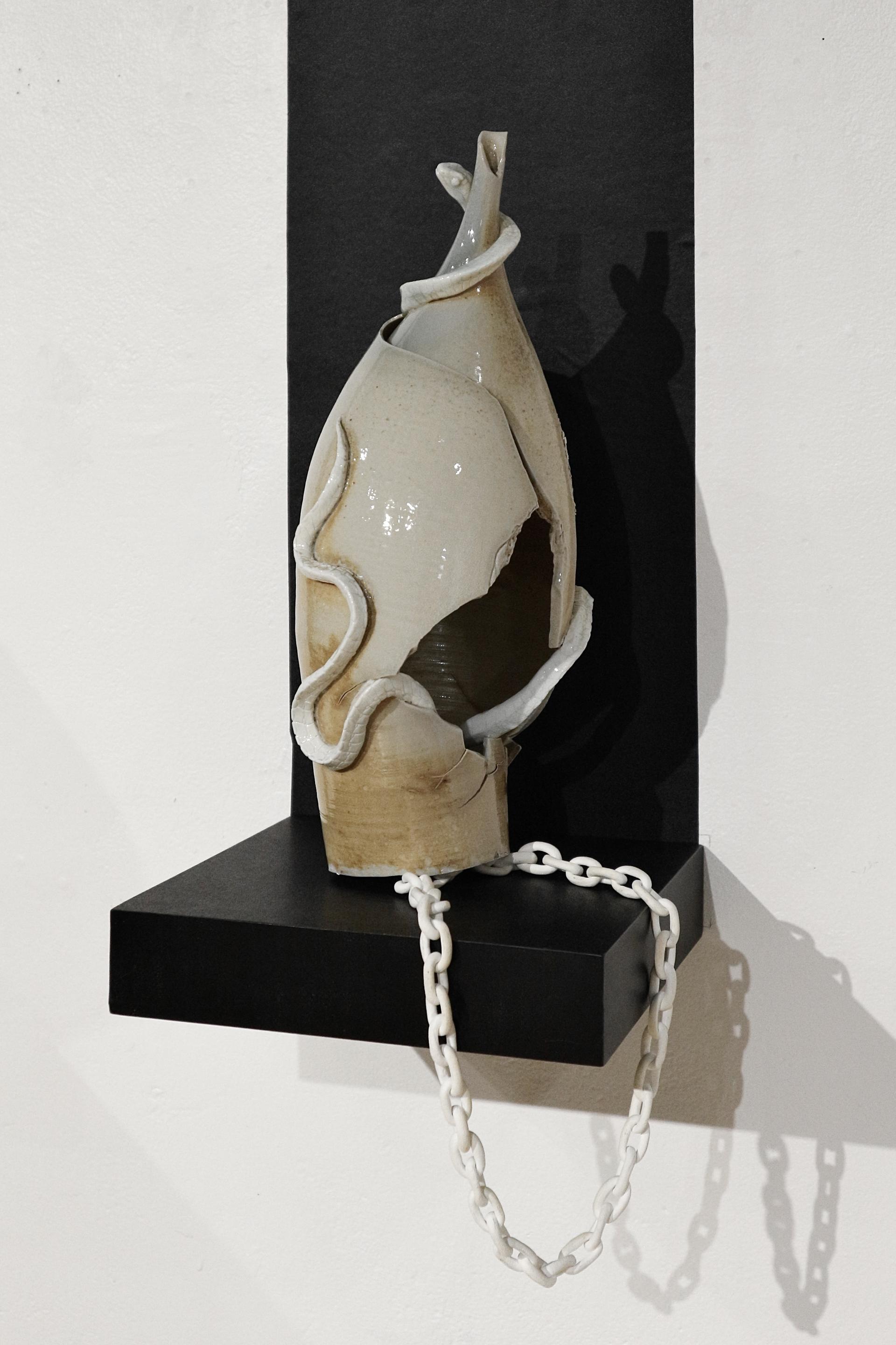 Soda-fired ceramic vessel with hand-sculpted snake around the neck.