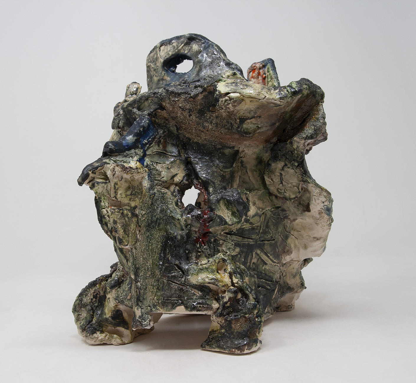 Ceramic object in the shape of a broken helmet with textural glaze