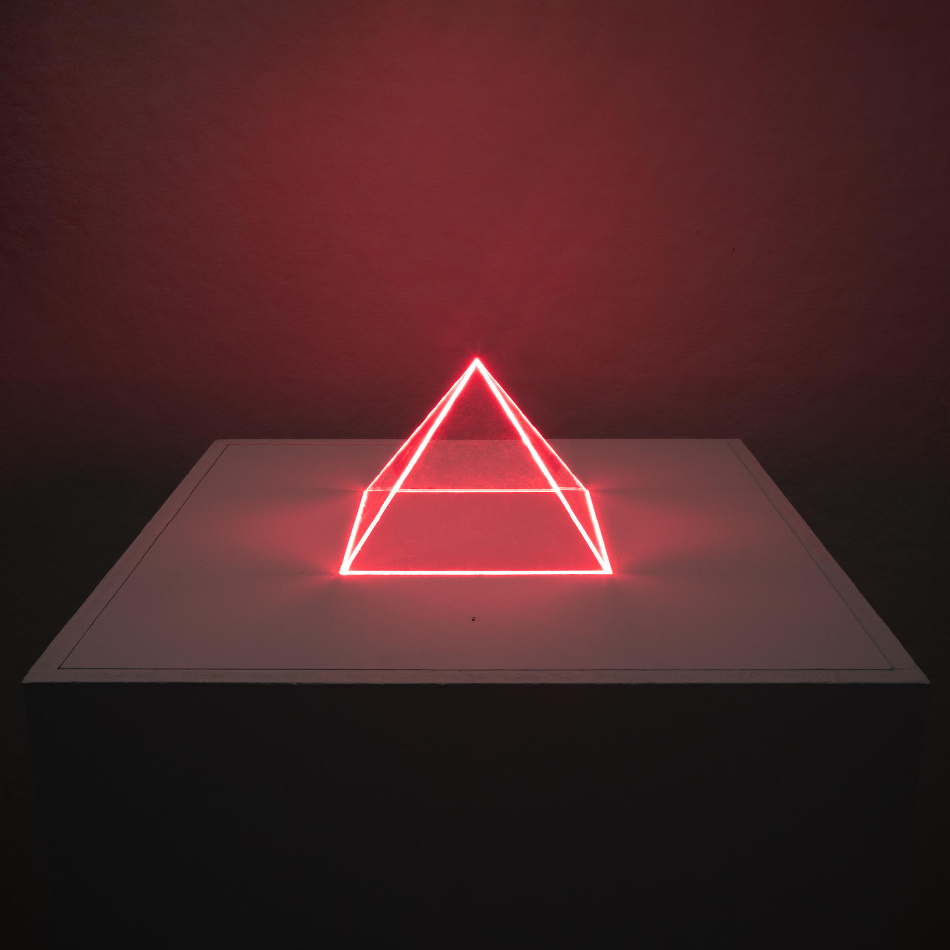 A transparent pyramid glows with its surrounding sound.