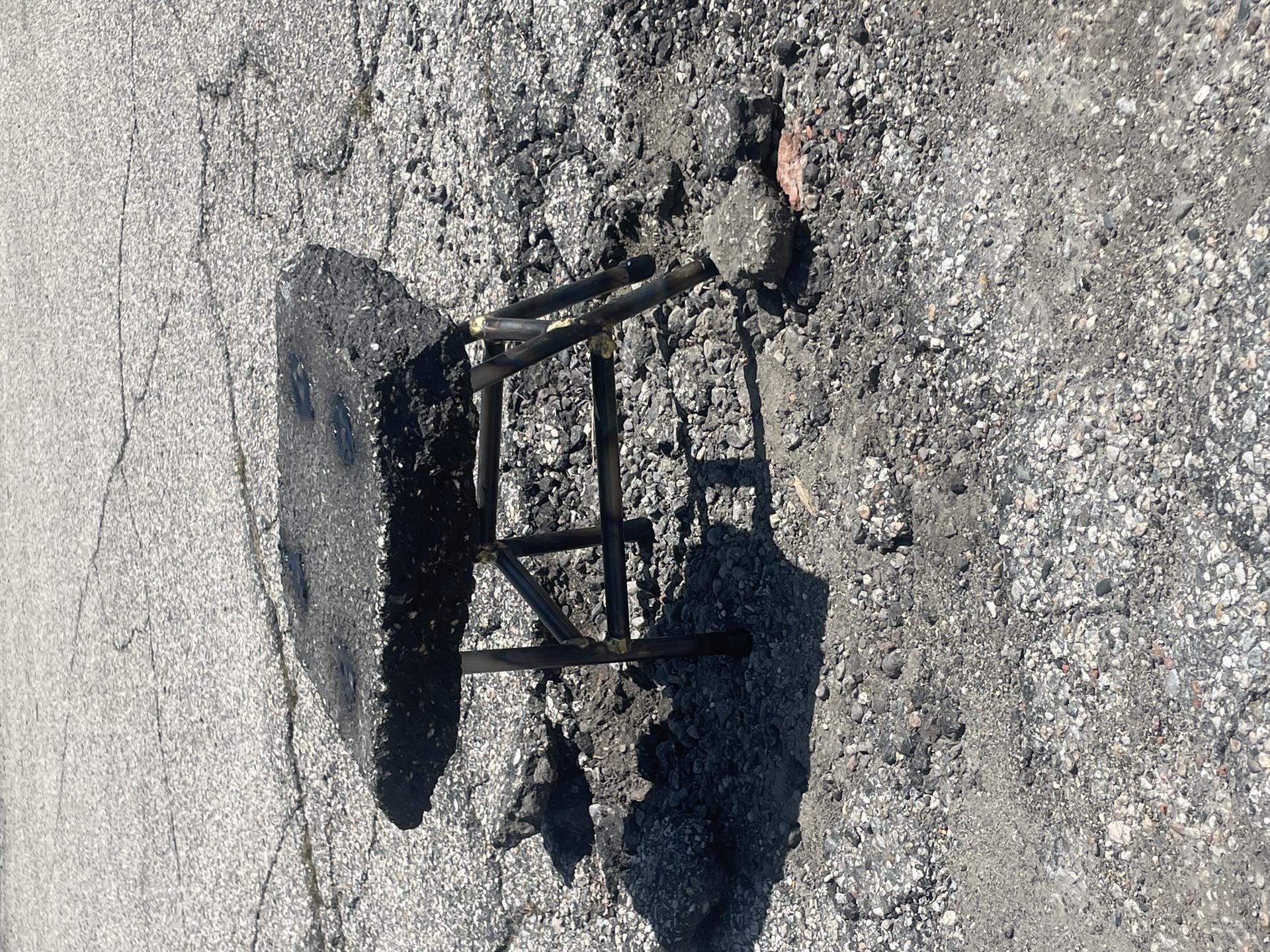 Asphalt stool on damaged roadway