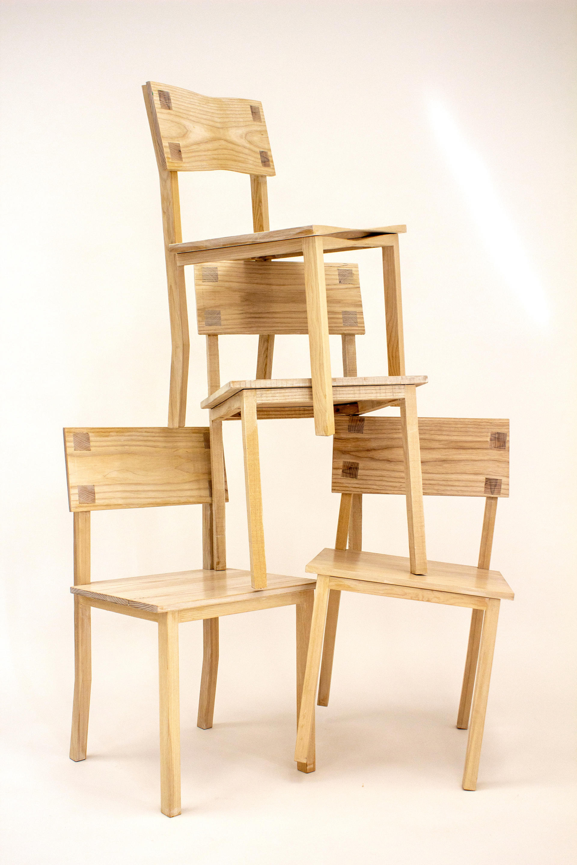 Group of dining chairs upon one another