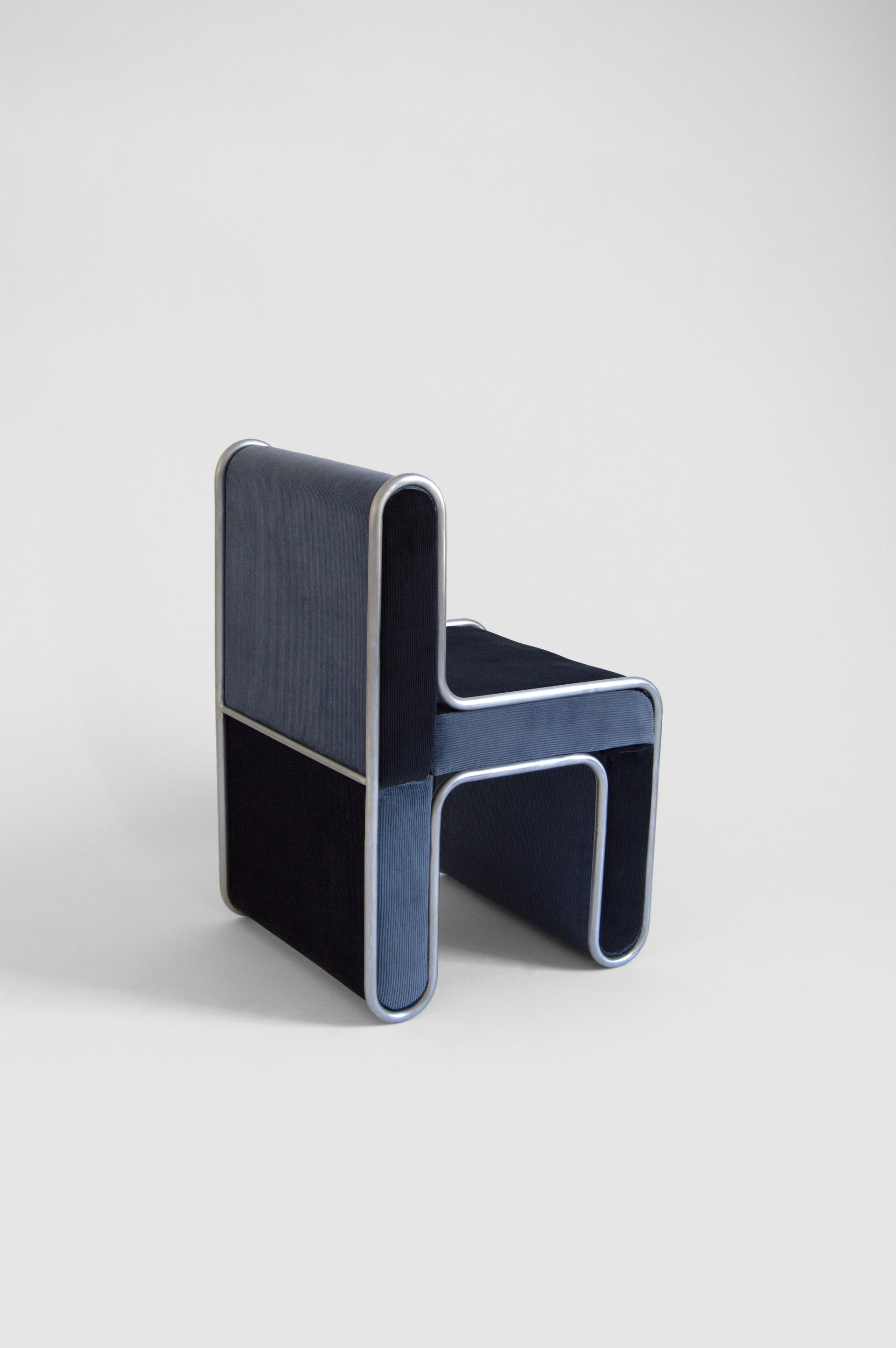 A chair built of upholstered pieces that press fit into a steel structure.