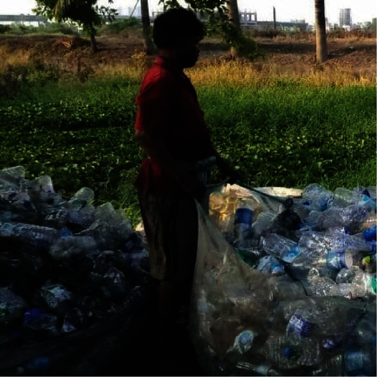 Kabadiwala sorting through garbage which is later sold to a bulk buyer.