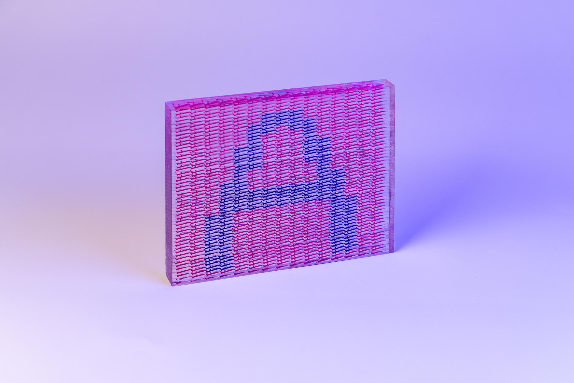 A semi-transparent block, showing a blue letter A against a pink background. In closer inspection, both the image and the background are formed by A is formed by little As.