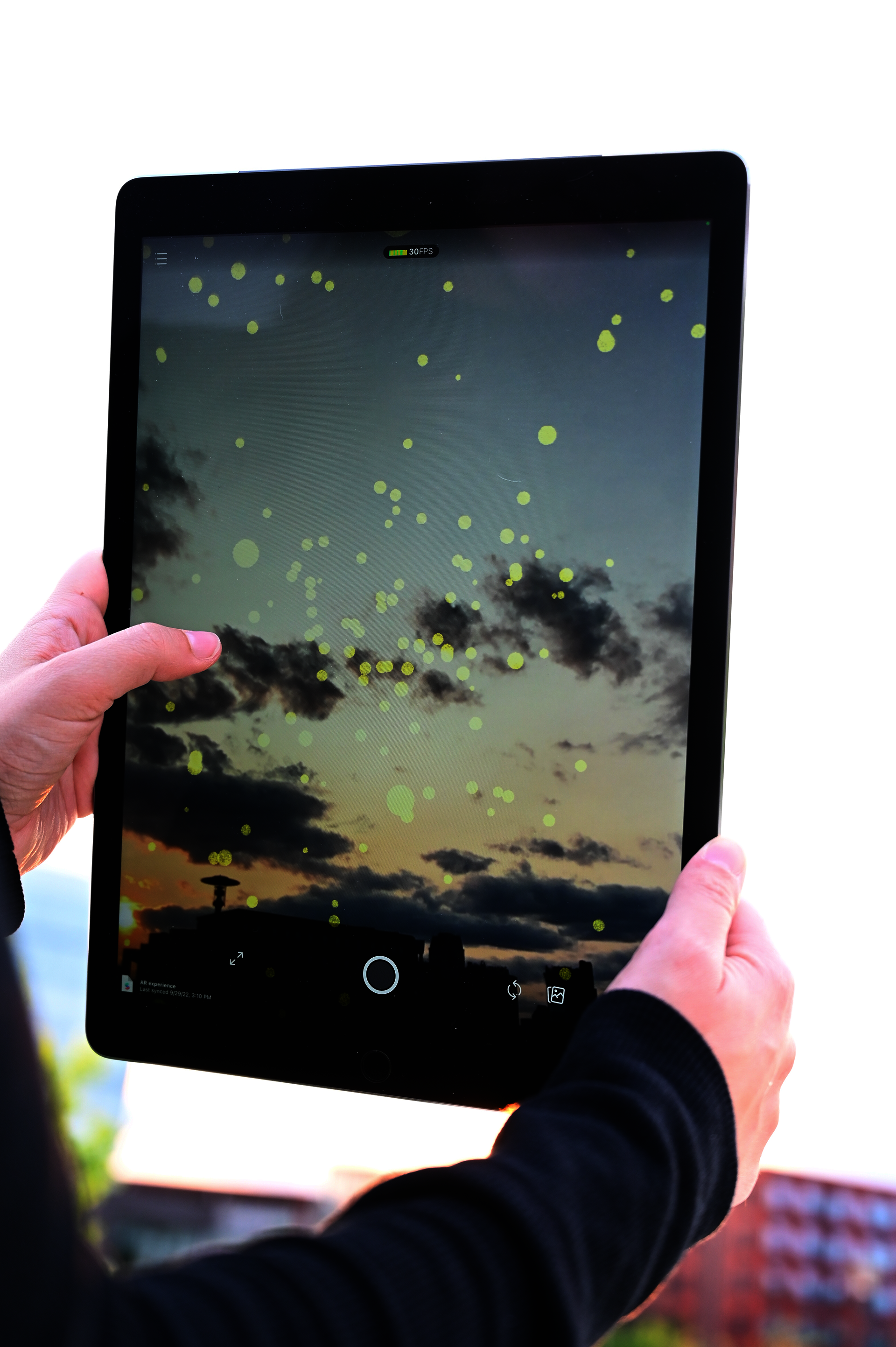 A person using app to create VR fireflies in Providence, R.I.