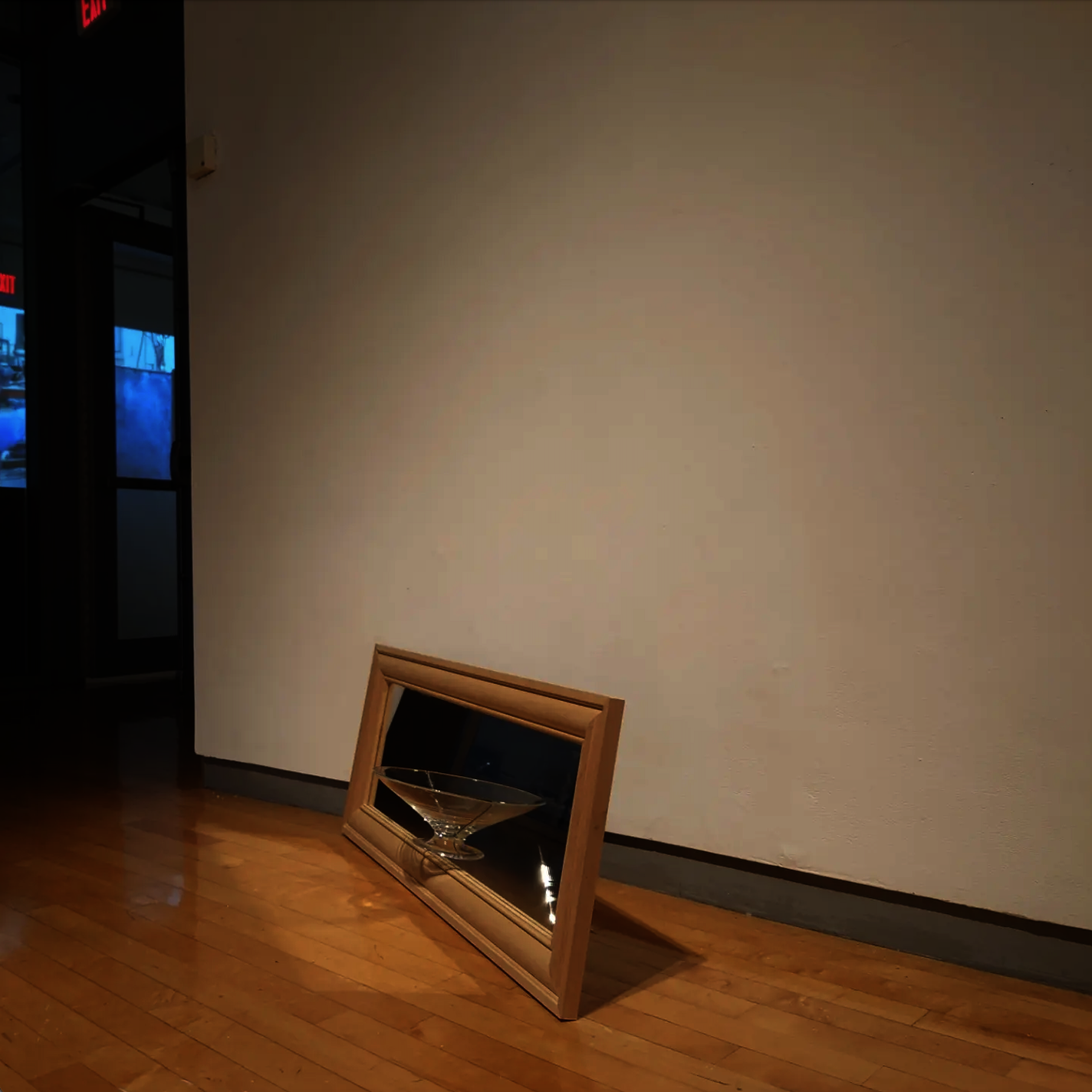 Front side of a mirror with a halved hand-blown footed dish glued on.