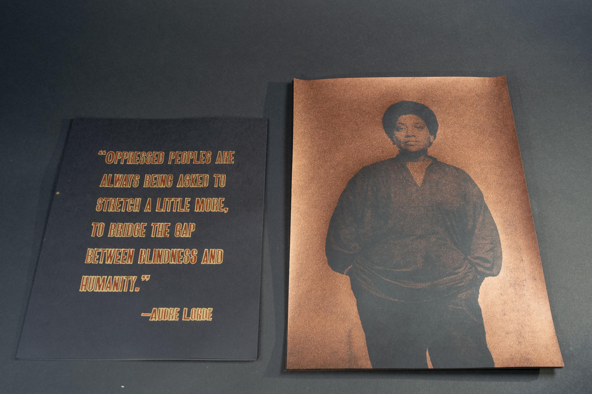 two copper colored prints, one of Audre Lorde and the other a quote by her