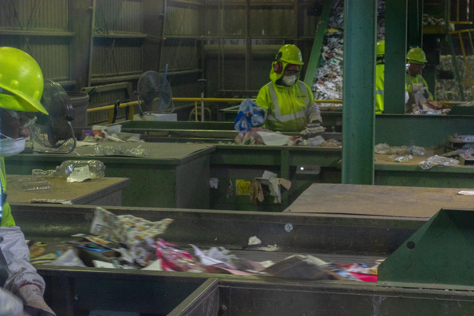 Photograph of two persons manually sorting waste at the Rhode Island Resource Recovery Center